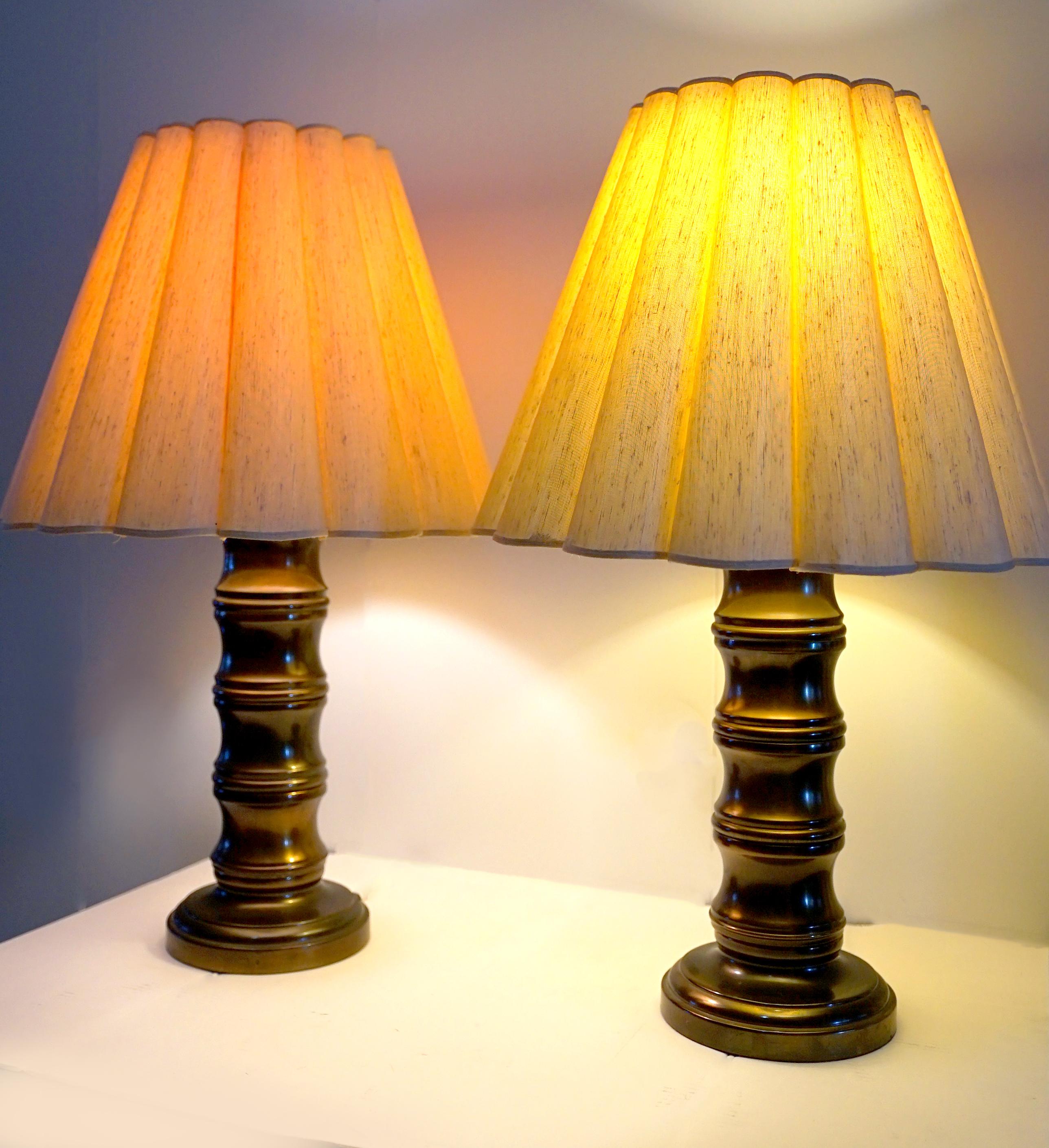 I love, love love this set of lamps for their condition and the silhouette. The burnished brass and the beautiful umbrella-like pleated shades that filter the light in a warm and luminous way, helps make these lamps irresistible. There is so much to