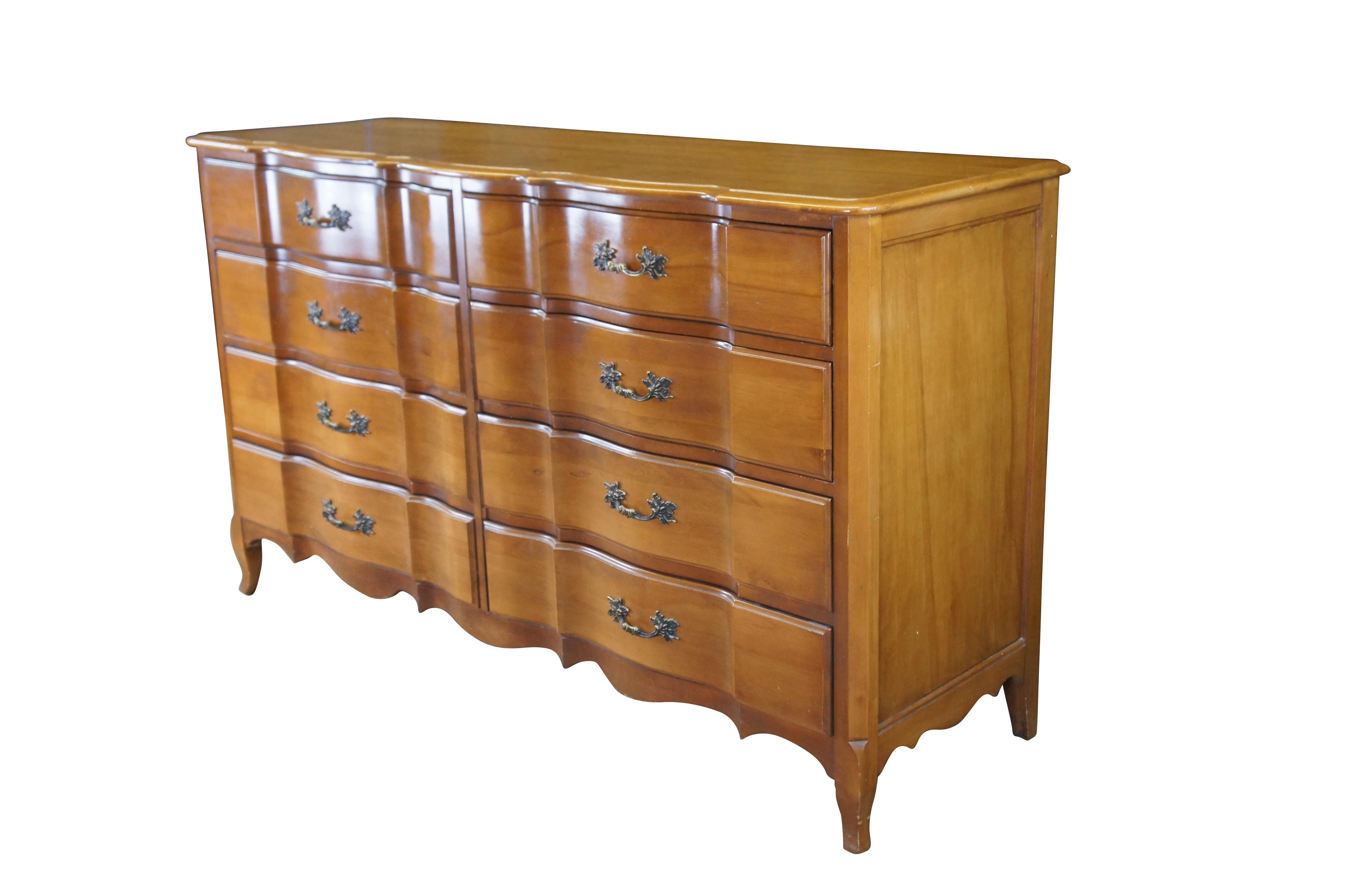 Mid Century French Provincial Burns Case Goods double dresser / lowboy / chest of drawers.  Made of walnut featuring serpentine form with eight drawers and brass hardware.

Burns Furniture Company, Founded 1939, a subsidiary of Union National,