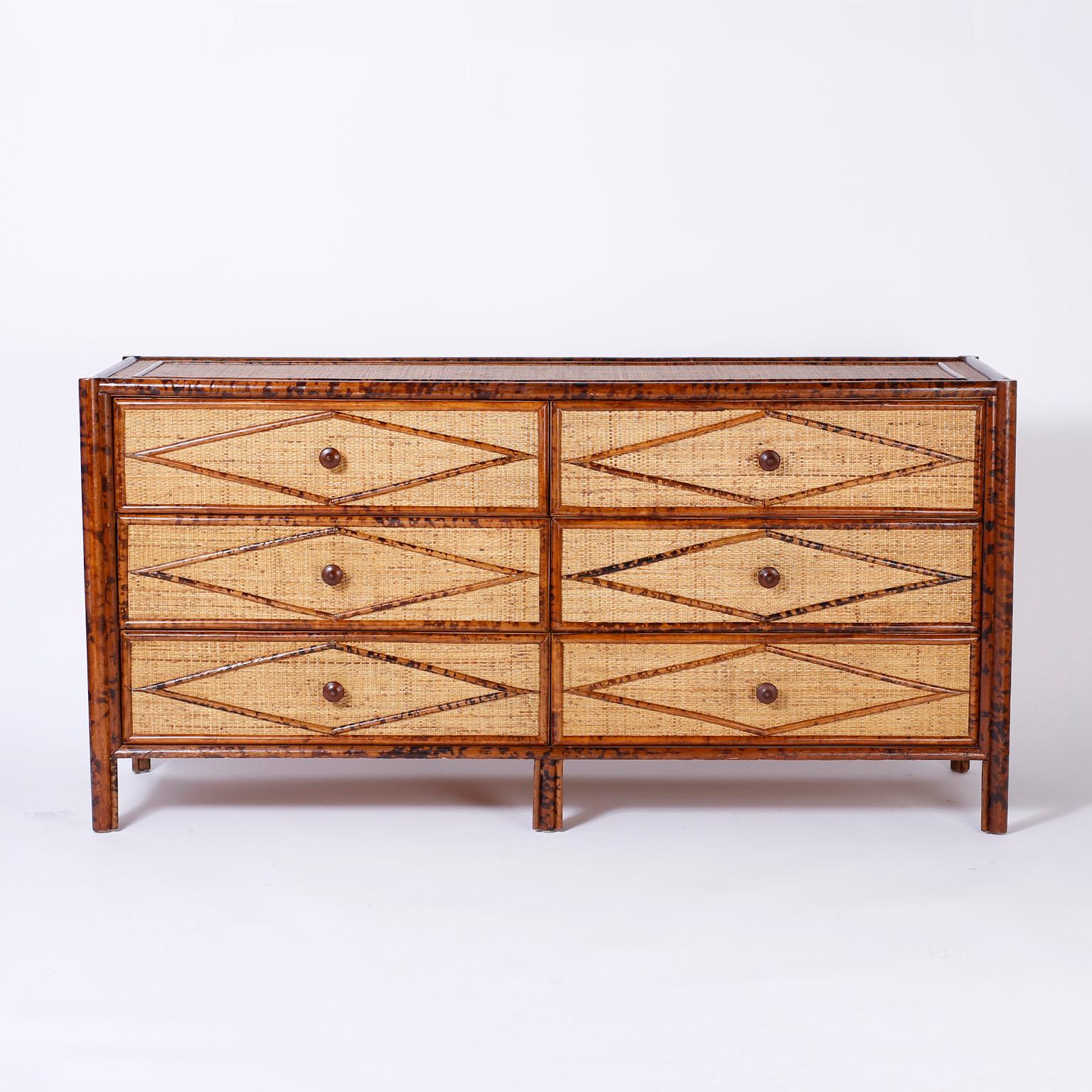 Handsome six-drawer chest or double dresser with a burnt bamboo frame and geometric designs over a grasscloth background. Perfect combination of timeless British Colonial and midcentury decor.