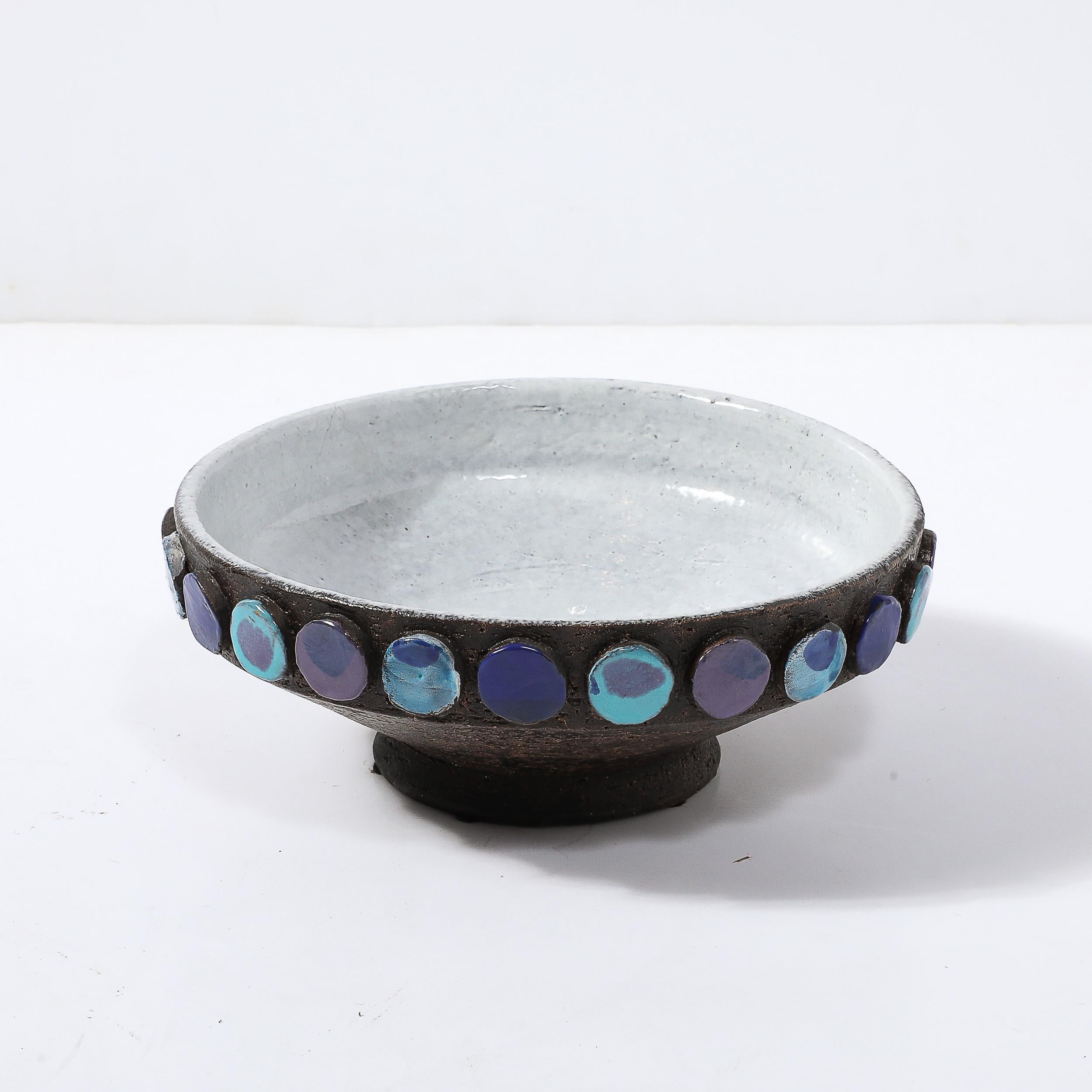 This materially stunning Mid-Century Modernist Ceramic Bowl in Burnt Umber W/ Multicolor Blue Sculptural Dots Motif by Aldo Londi for Vistosi originates from Italy, Circa 1960. This piece features a beautiful array of applied detailing