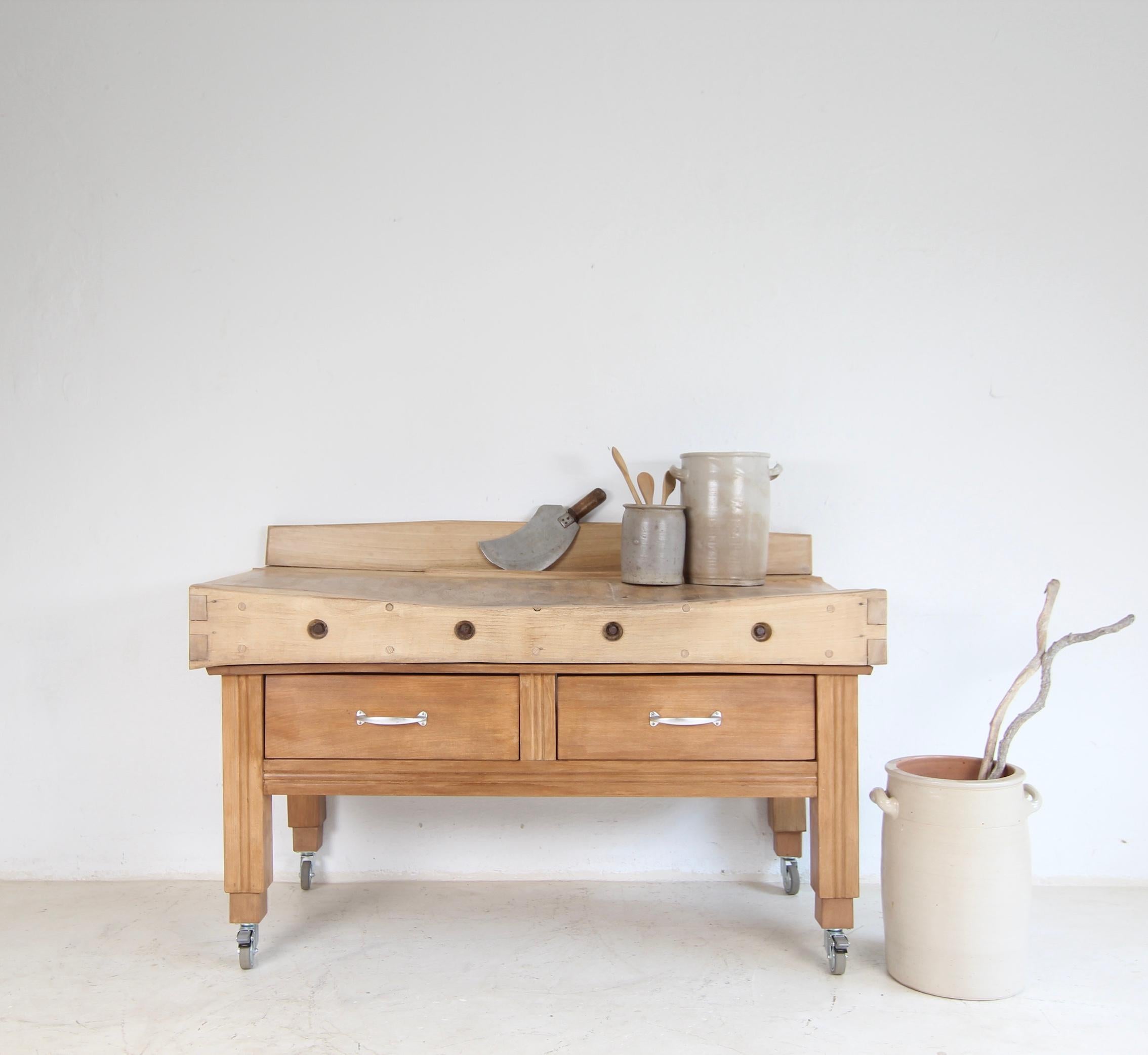 A Mid-century butcher's block. Solidly crafted from beech wood. 

Since the Middle Ages, the profession of butcher has been one of the most respected and lucrative occupations. Even back then, the first butcher's blocks were created with a slab