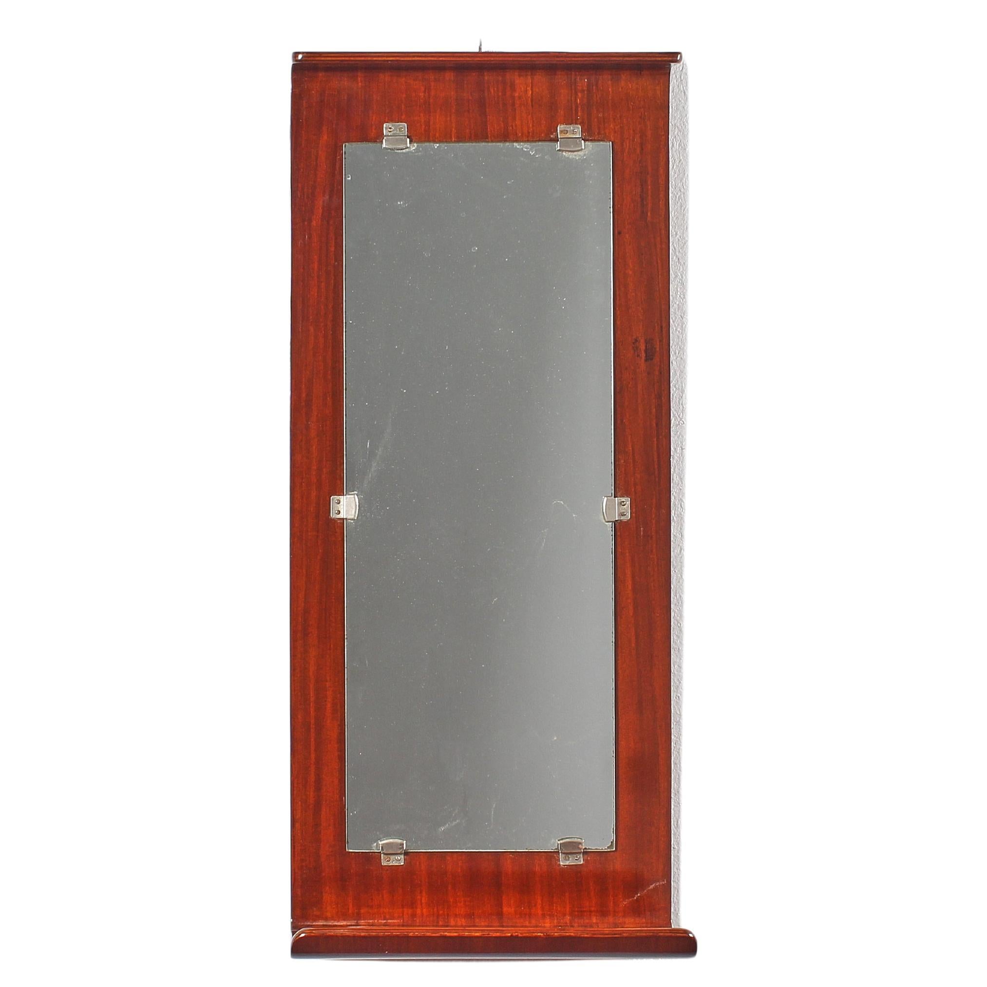 Rectangular mirror with plywood support curved to form a double shelf, top and bottom, bathroom items holder. Italian manufacture attributable to Carlo Graffi for Home Torino, 1960s. Restored.
Wear consistent with age and use.