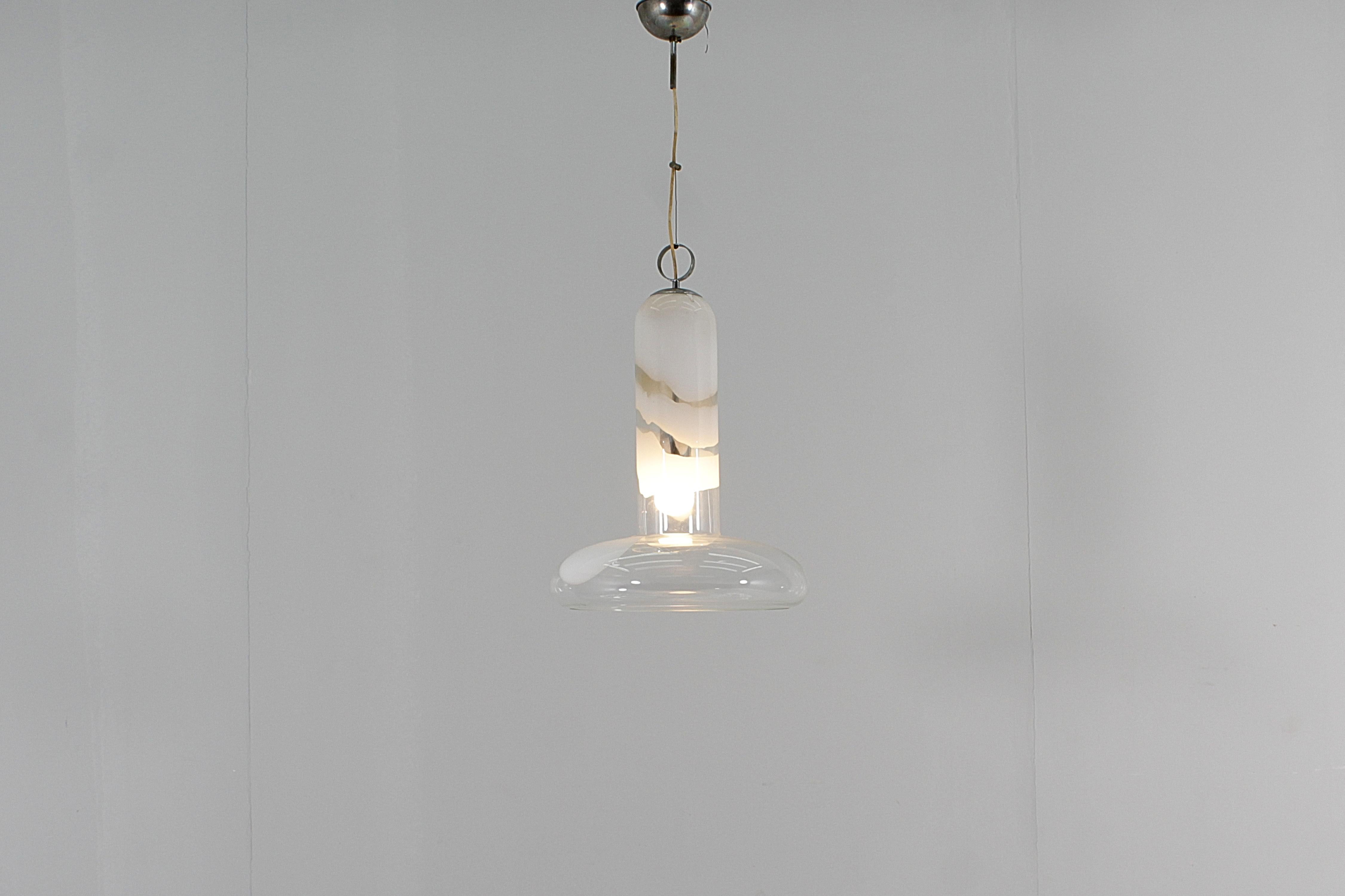 Stunning suspension lamp attributable to Carlo Nason for Mazzega, 1960s. Transparent Murano glass bell with irregular inclusions in white 