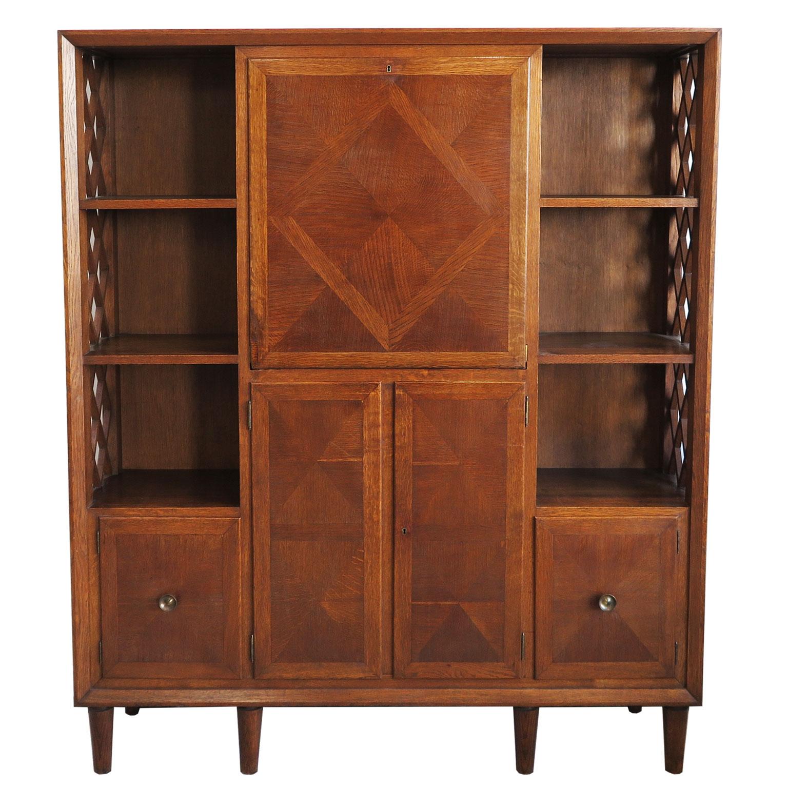 Early midcentury cabinet attributed to E. Lanzia from Italy circa 1940s. The oak frame features subtle parquetry inlay designs with trellis detailing on the sides. It houses four cabinets and six niches. 
Ideal to store kitchenware or to use as a