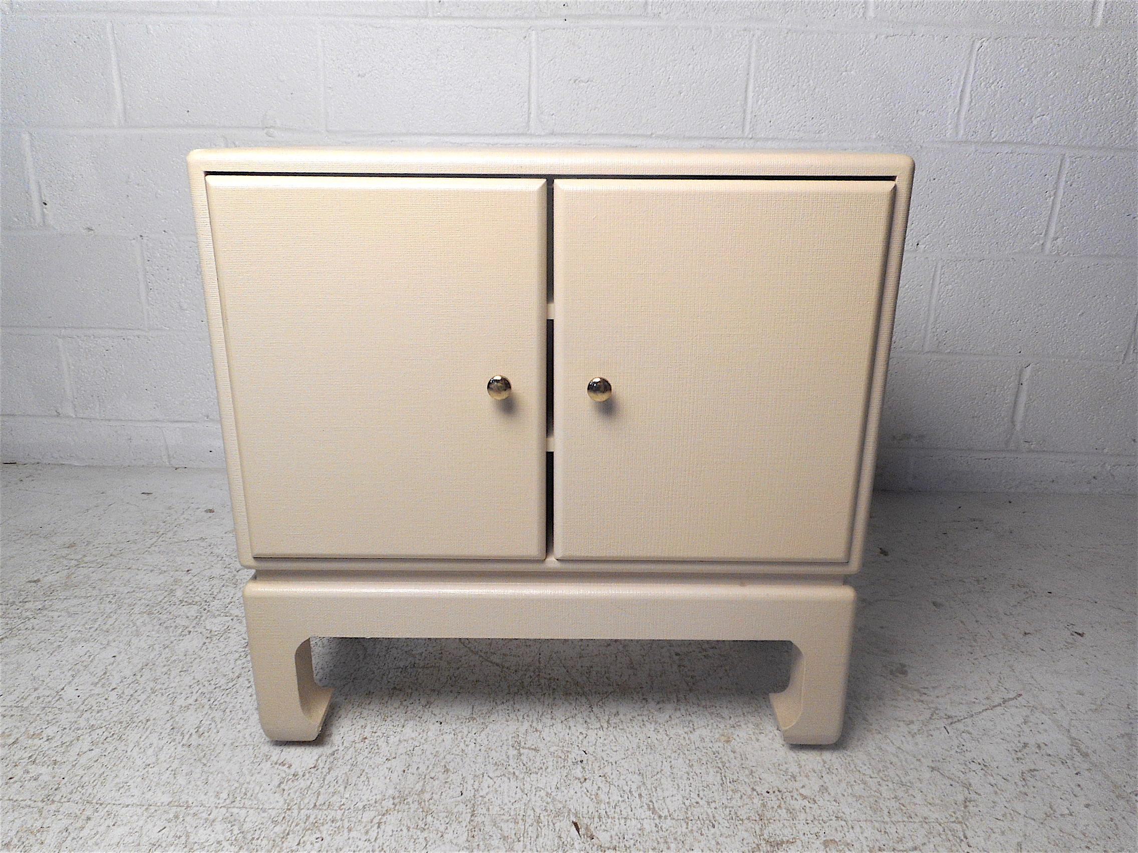 Beautiful midcentury compact free-standing cabinet. Linen-wrapped piece with a finished back. Stylish addition to any modern interior. Please confirm item location with dealer (NJ or NY).