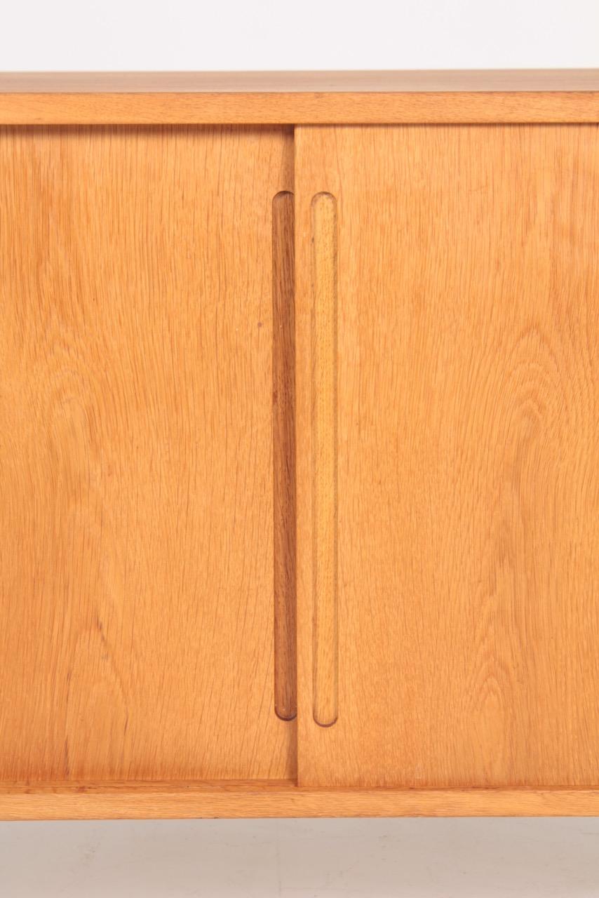 Cabinet in oak, designed by Hans J Wegner for RY cabinetmakers in the late 1950s.