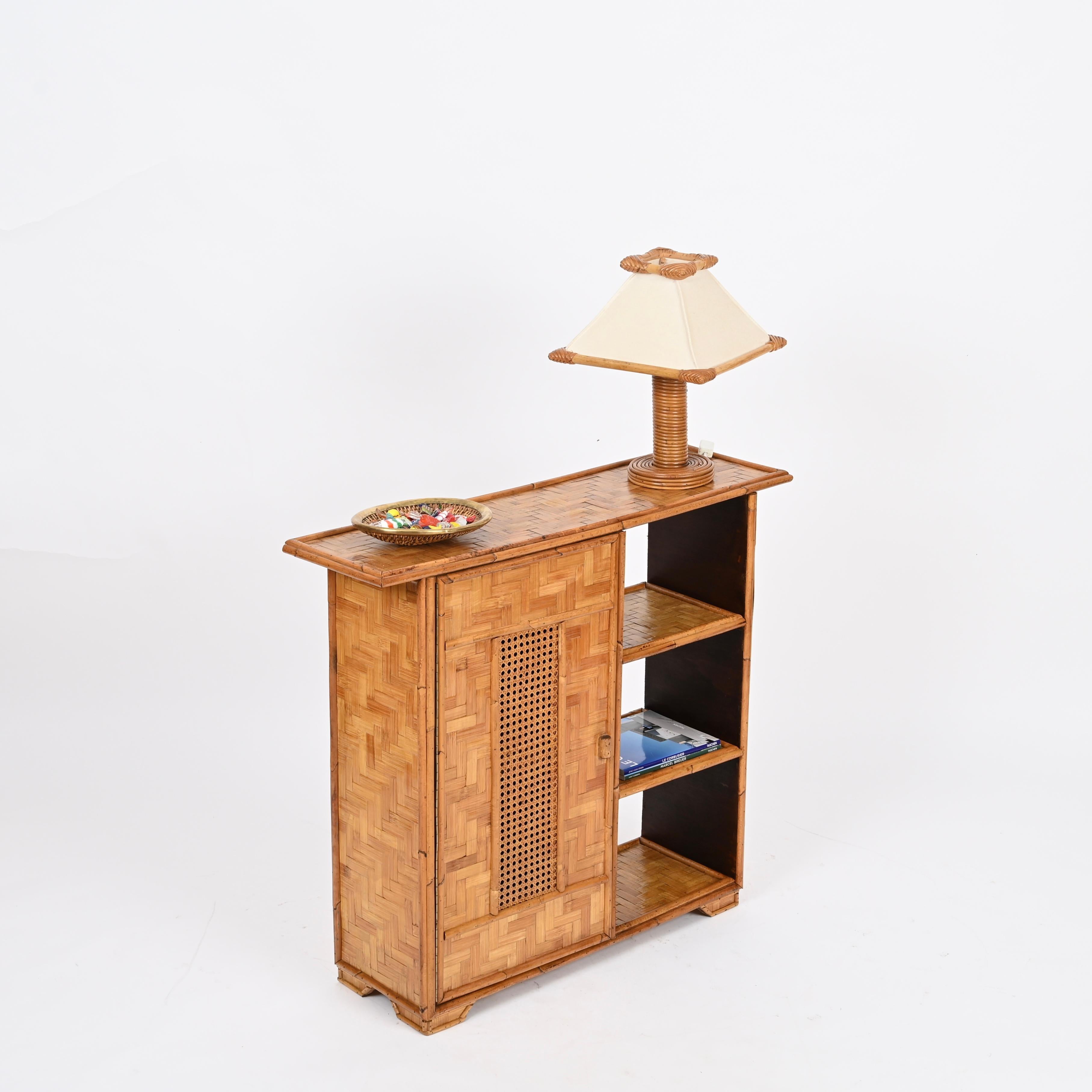 Delightful mid-century tiny storage cabinet or bookase in bamboo, Vienna straw and woven rattan. This lovely French Riviera style cabinet was produced in Italy in the 1970s.

This organic cabinet is in amazing conditions and has a charming