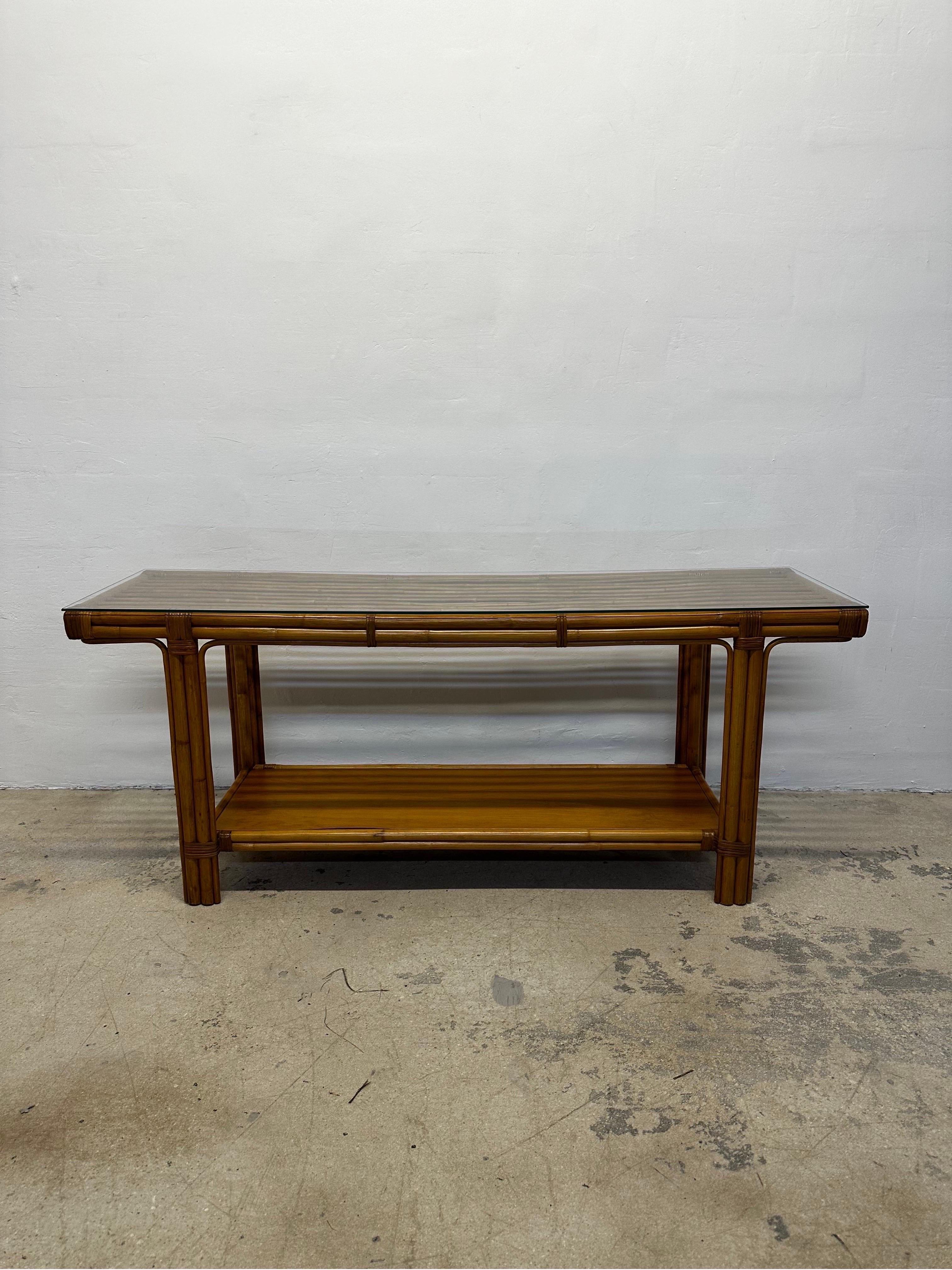 Mid-Century natural bamboo and glass top console table by Calif-Asia circa 1970s.  The bamboo base as well as wood shelf has been expertly restored and the 1/4” glass top is new.
