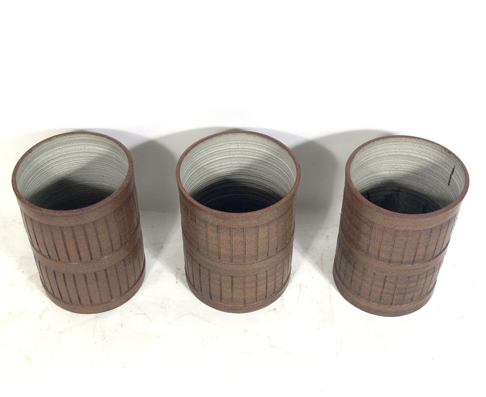 Midcentury ceramic planters, American, circa 1960s. These pieces are unsigned, so we are unsure of the ceramicist, but the estate where they were purchased from told us they were purchased in California. They have clean lined incised decoration and