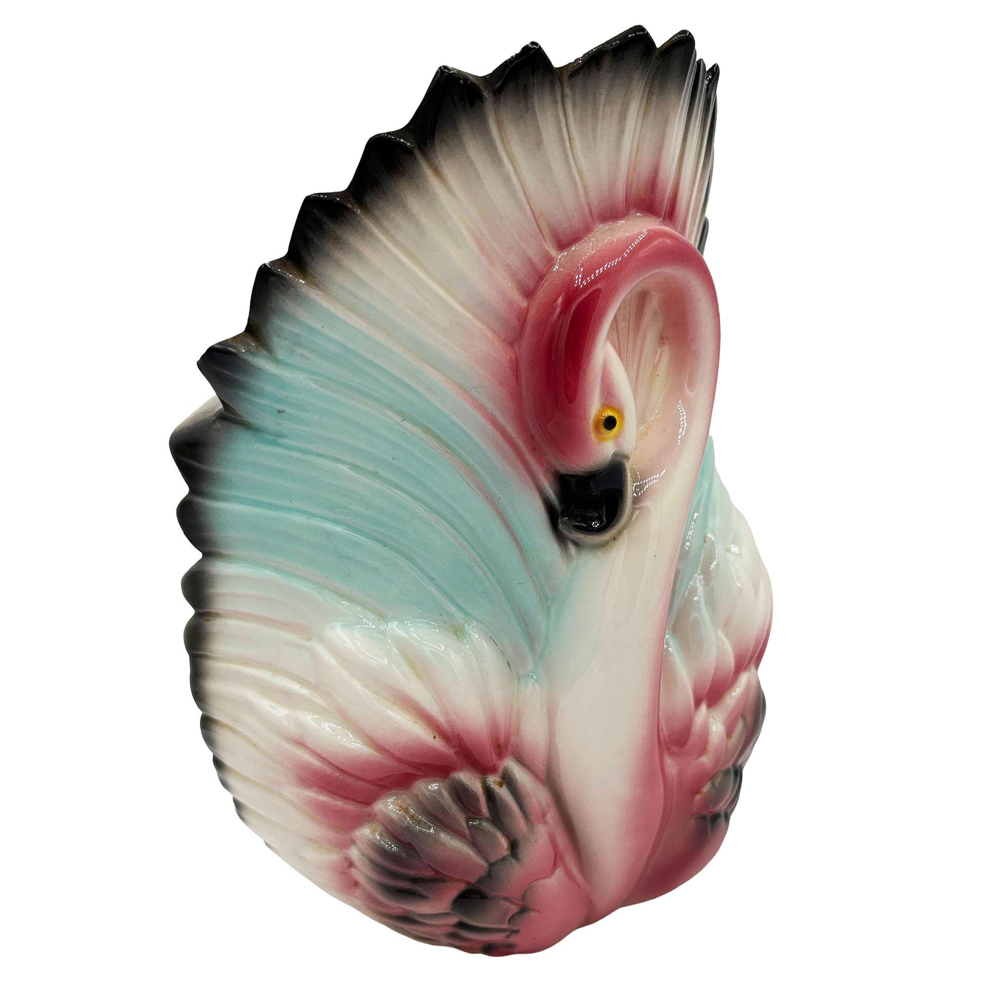 Mid-century pink and green ceramic California pottery flamingo TV accent lamp. The table lamp features a beautifully detailed pink flamingo with open wings form the shade for the lamp. It comes in a gloss finish that highlights the rich pinks,