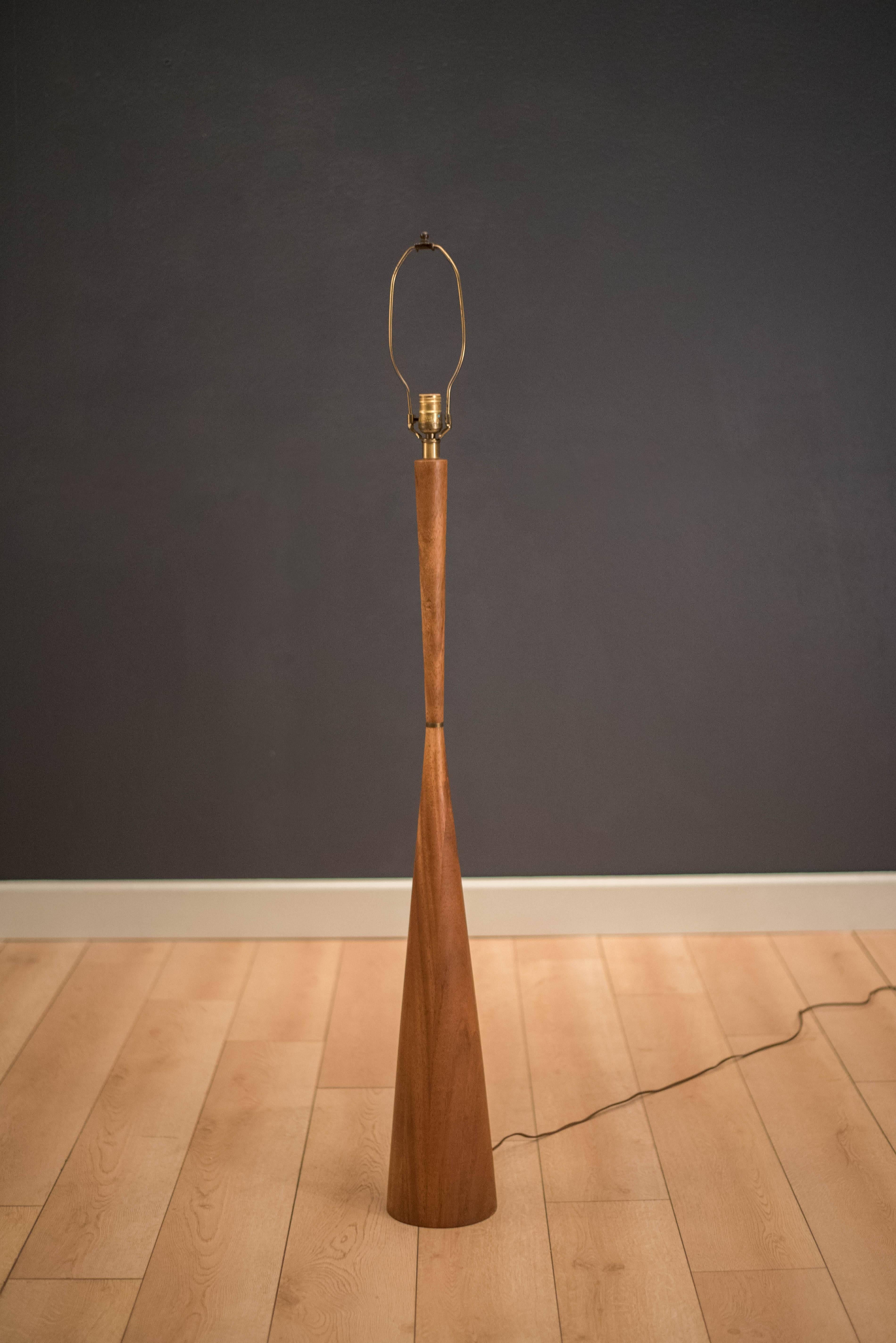 Vintage solid mahogany floor lamp designed by Raymond Pfennig for Zina Lamp Co. This sculptural piece is accented with a brass ring and includes the original shade. Functions with a three way switch.