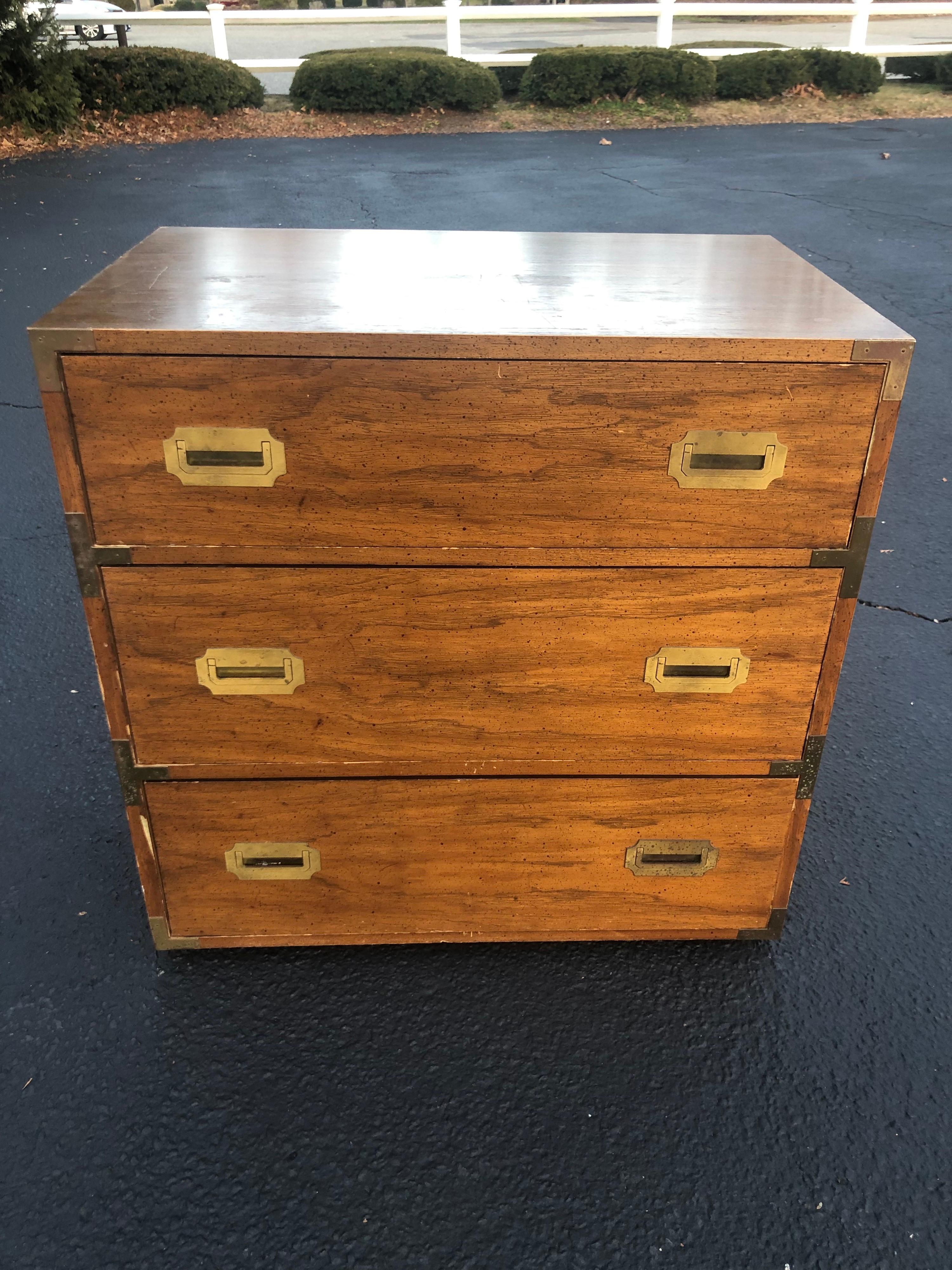 Mid-century campaign chest. Classic, timeless piece which will never go out of style. Heavy solid wood construction with a veneer overlay. No signature found but in the style of Henredon. Three drawers give ample storage but this is a nice