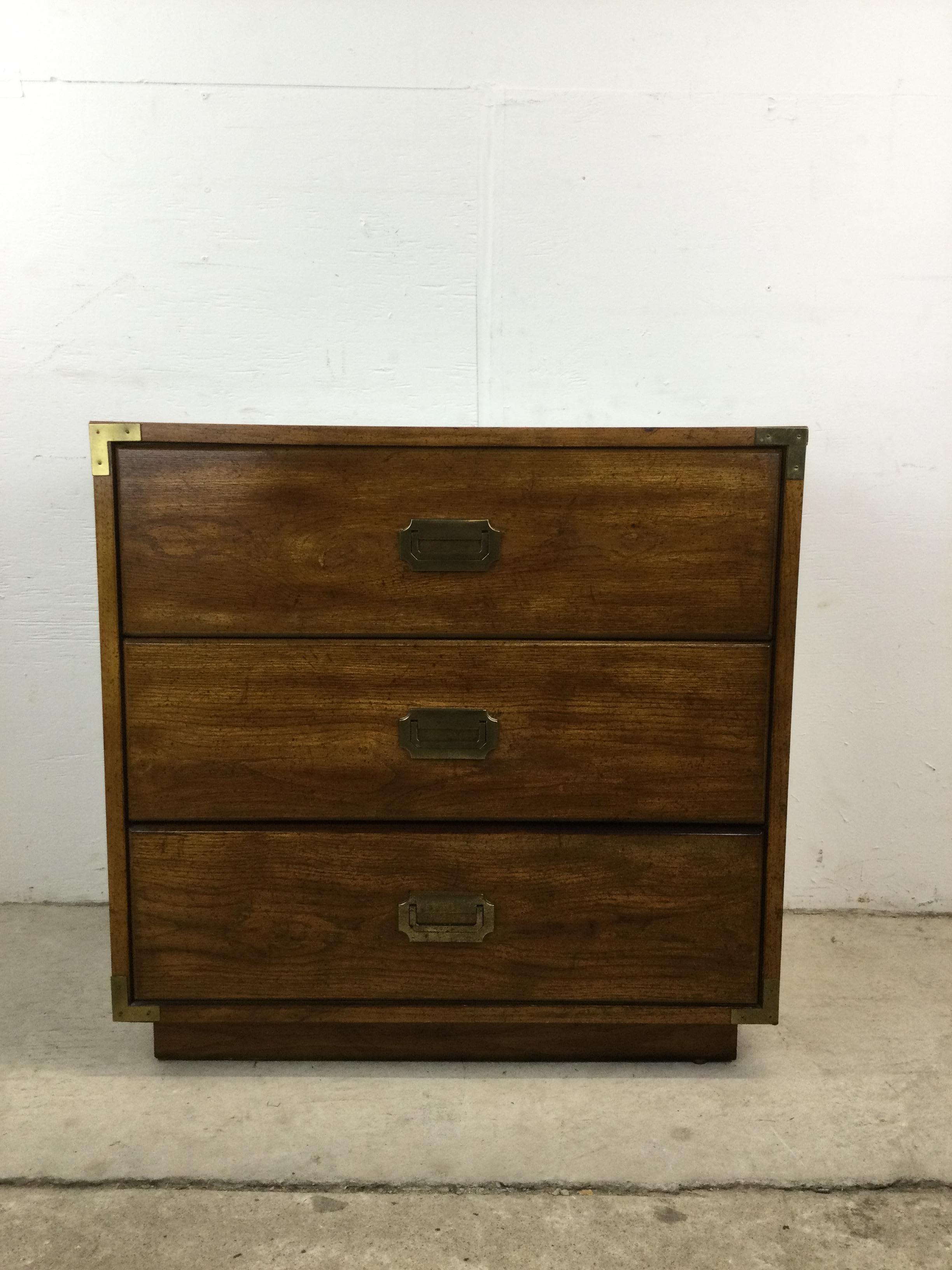 This mid century campaign style dresser features dark oak finish, durable vinyl top with faux wood grain, three dovetailed drawers, and brass accented hardware.

Matching three drawer chest & highboy dresser available separately.

Dimensions: 30w
