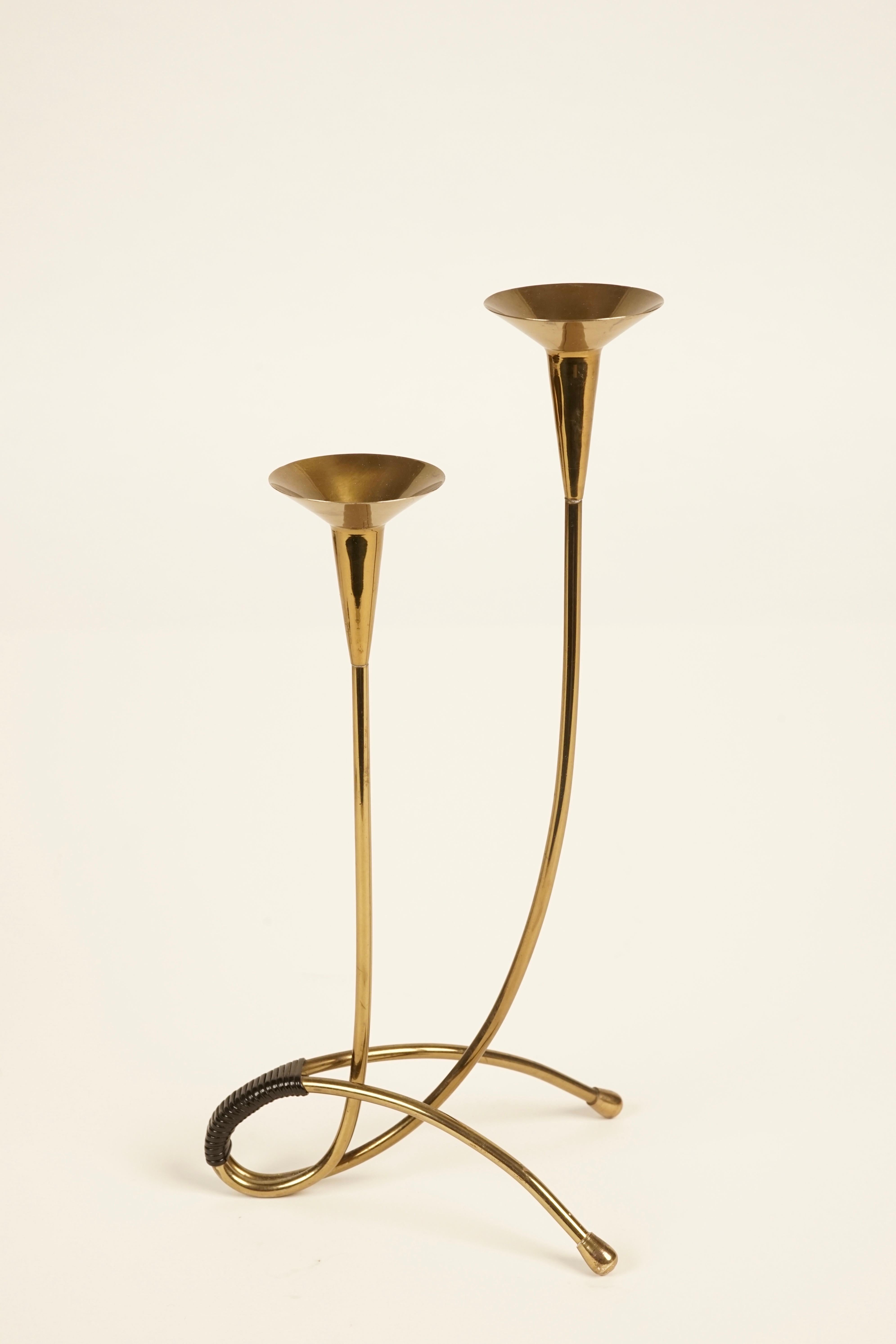 Decorative midcentury candleholder from Austria. It comes as a set and includes scissors for controlling the wick and another element for snuffing the frame. Made of high quality brass, all the pieces are in very fine condition. Scissors and snuff
