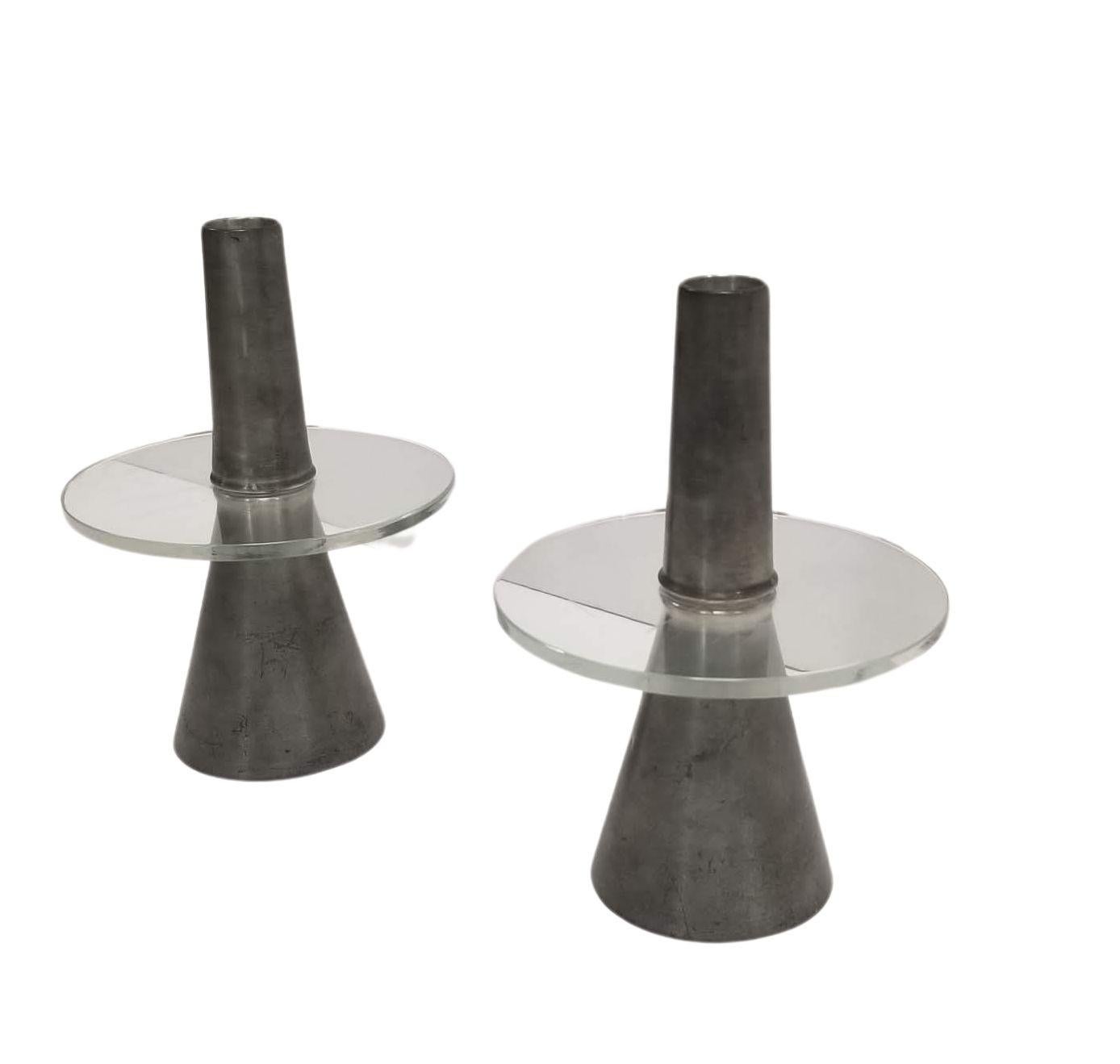 This elegant candlestick seamlessly marries pewter and glass in a sophisticated design composed of three distinct parts.
The foundation is a gracefully tapered conical base, providing stability and aesthetic appeal.
At its summit, a glass disc