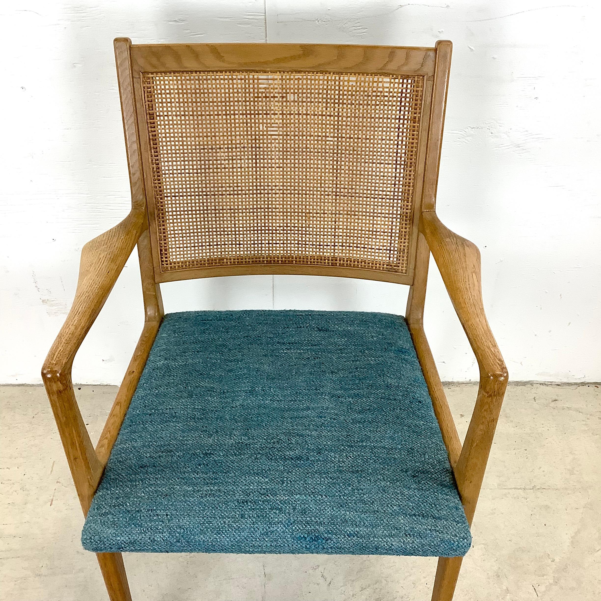 The comfortable proportions and upholstered seat of this vintage armchair make it an ideal fit for use as a striking office desk chair or an eye-catching addition to your dining set. The mid-century modern sculptural qualities of the vintage wood