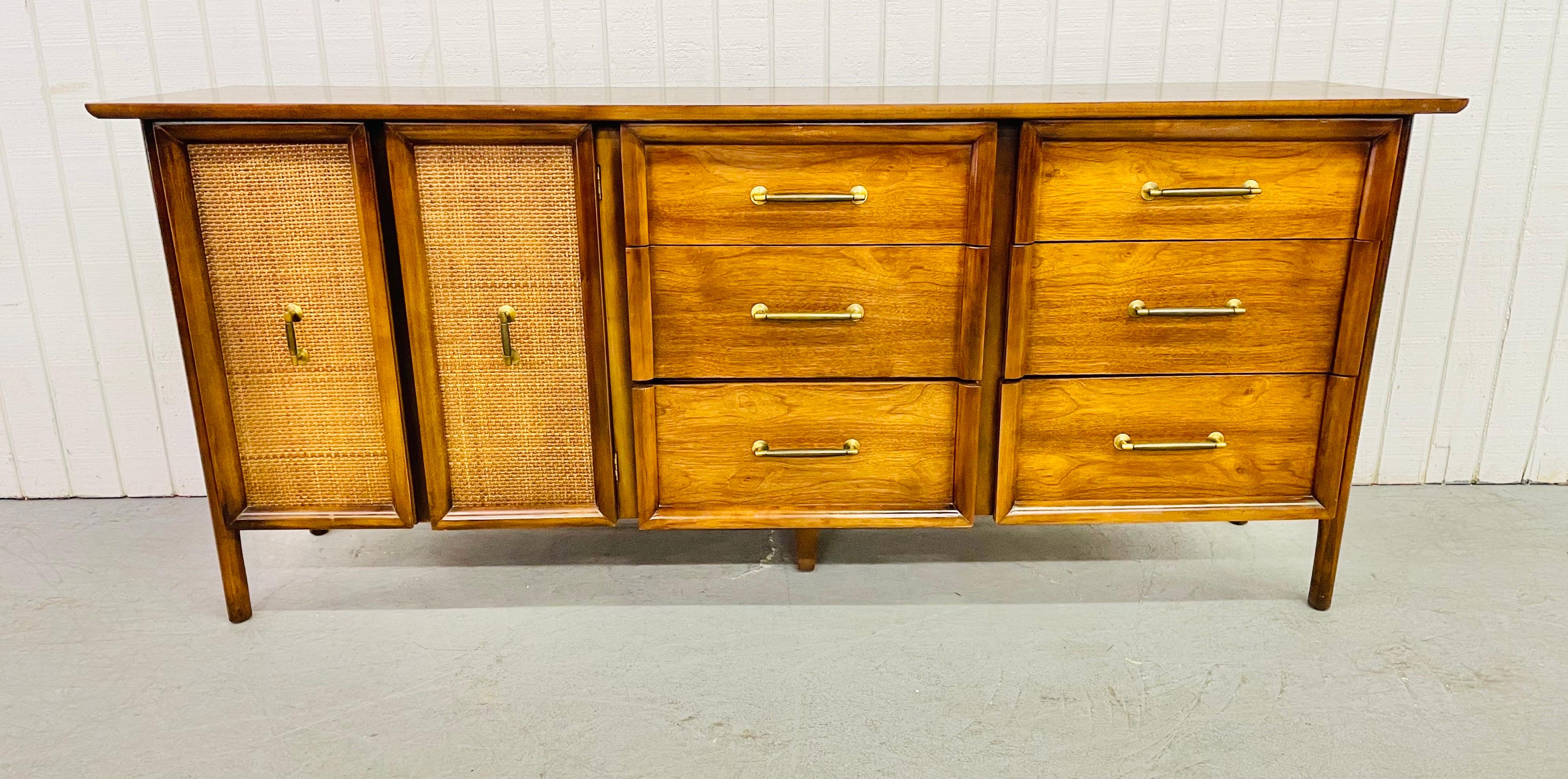 This listing is for a Mid-Century Walnut Triple Dresser. Featuring nine drawers for storage, cane doors on the left that open up to three hidden drawers, six drawers on the right, original hardware, and a beautiful walnut finish.