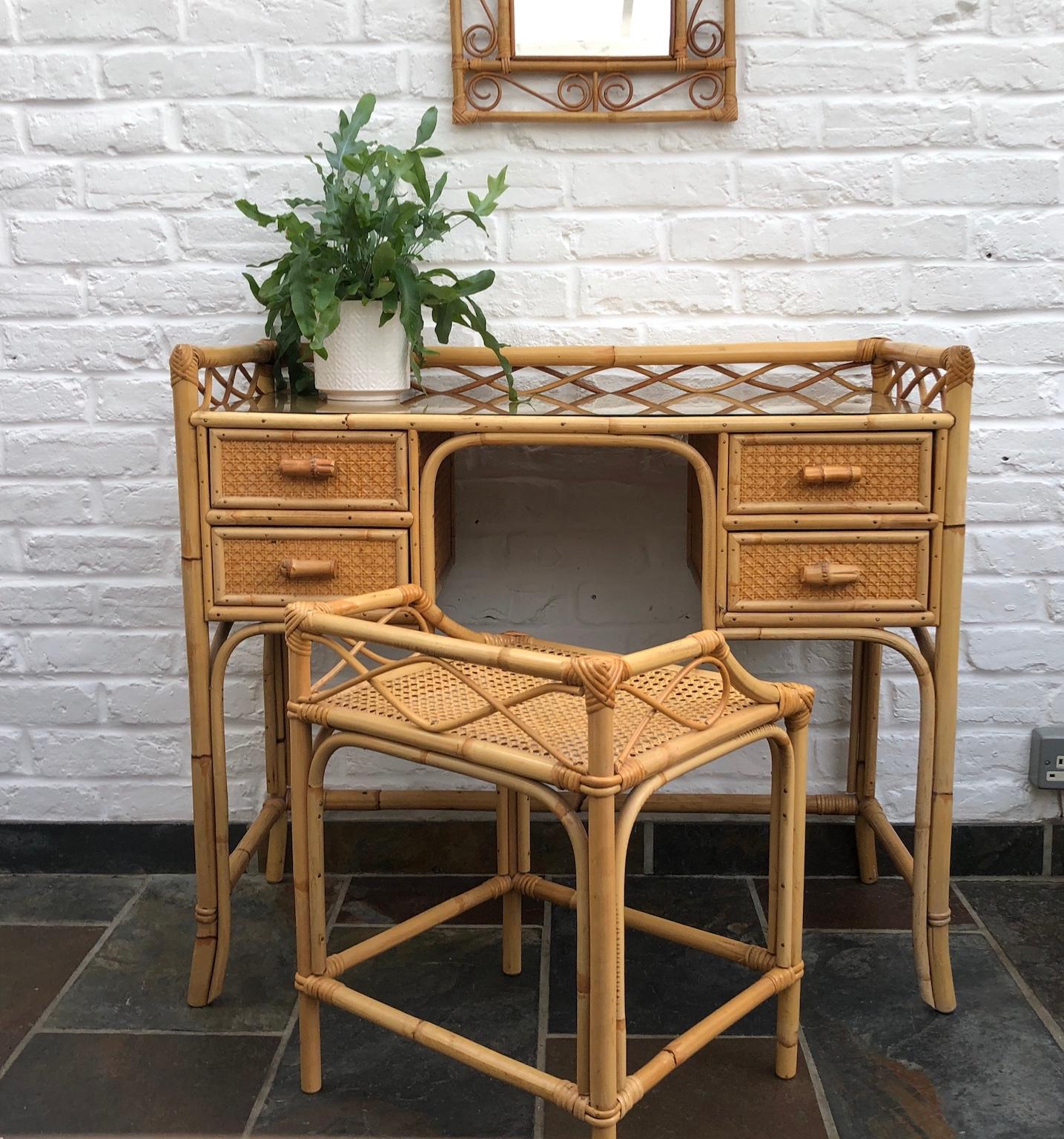MidCentury Rattan cane dressing table / small desk, stool and mirror set, England, 1970s

This is a beautiful set consisting of a dressing table or small desk, matching stool and wall mirror. 
Made by English company ‘Angraves of Leicester’, who
