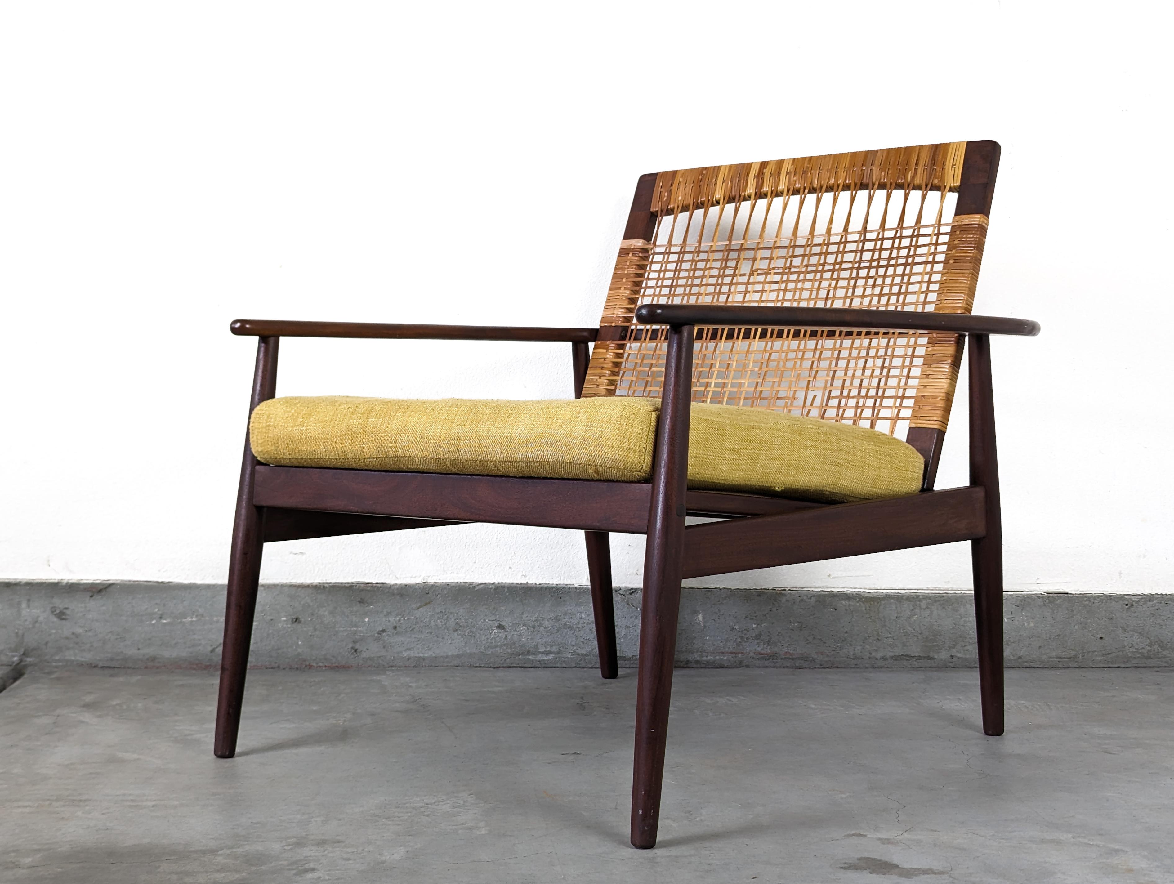 Presenting a rare opportunity to own a piece of mid-century Danish design history - an authentic Hans Olsen armchair for Juul Kristensen. Crafted in Denmark in the vibrant era of the 1960s, this vintage piece is a testament to the enduring appeal of