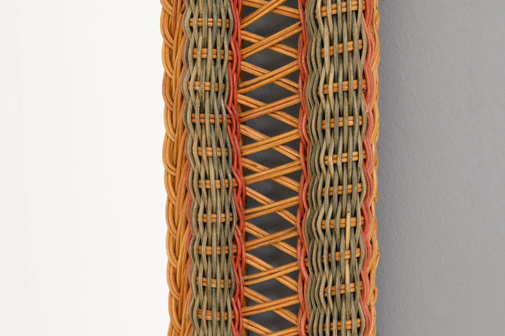 Mid-Century cane mirror with colour details. France circa 1970.

H 78cm x W 56cm x D 4cm
