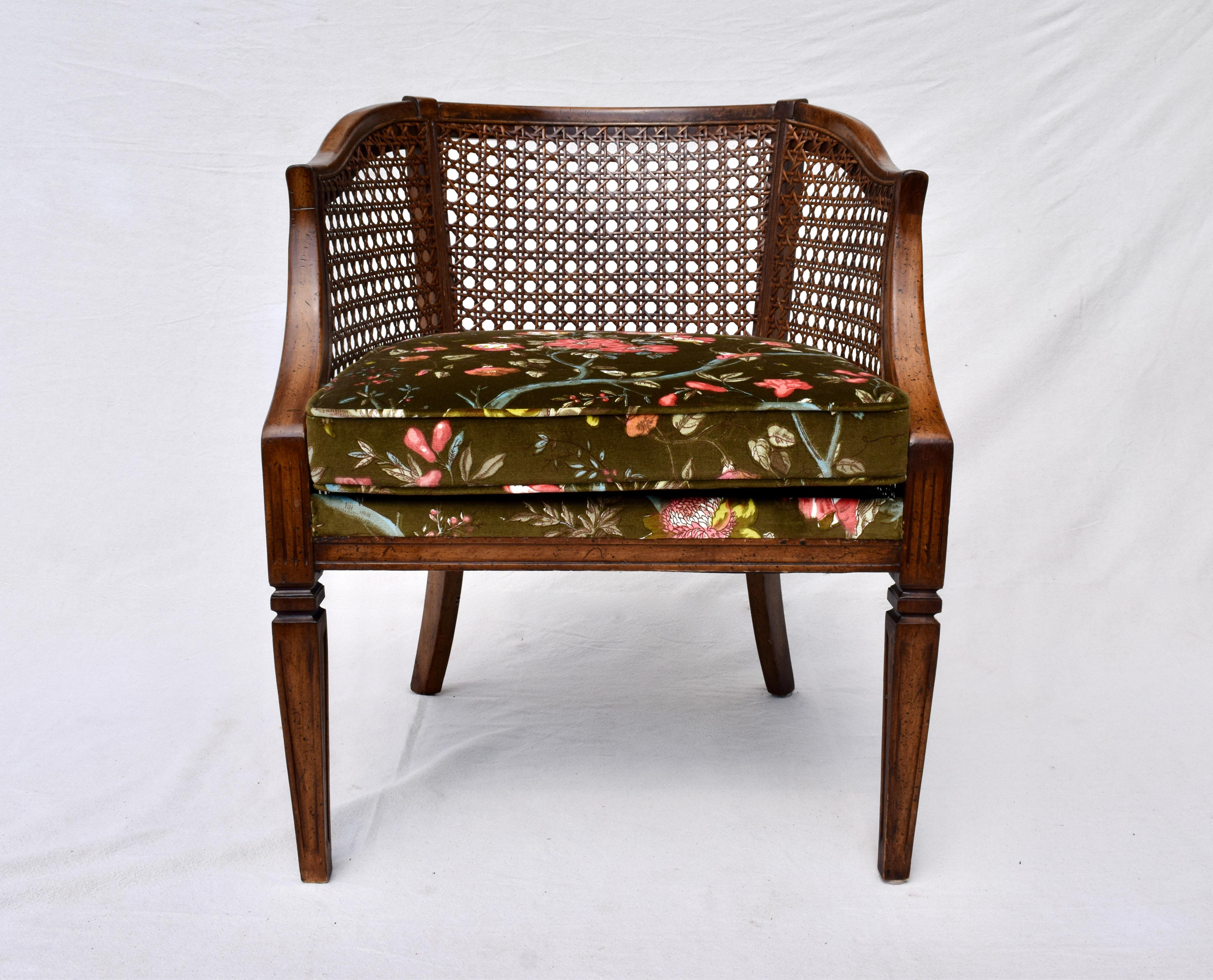 Fabulous barrel back armchair featuring caned sides and back with Directoire styling to the legs of walnut construction with new custom cushion upholstered in Brunschwig & Fils floral velvet. The color of the ground is of deep olive & chocolate