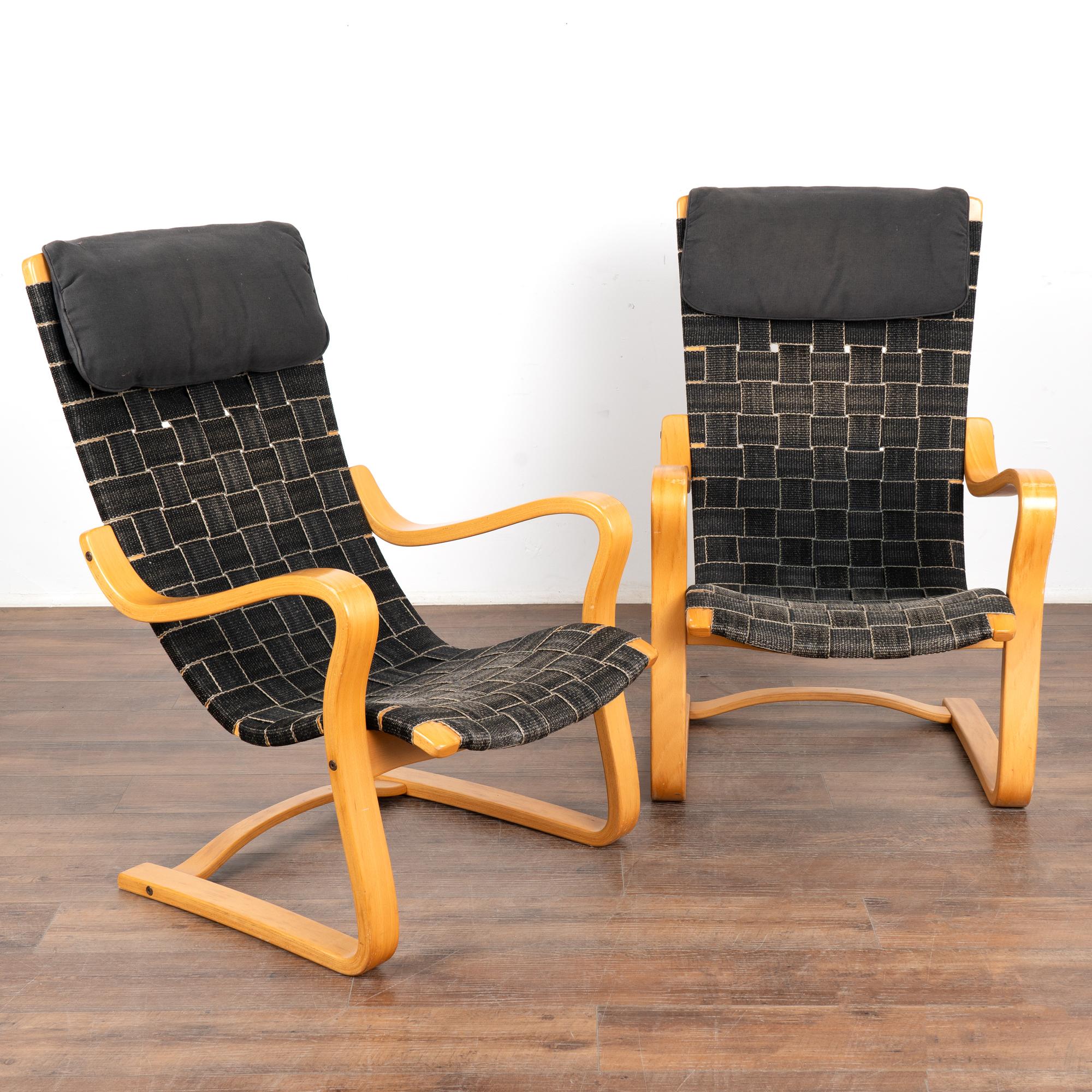 Pair of mid-century modern cantilever lounge chairs with original black webbing on a traditional molded beech wood frame. No makers mark.
Black webbing shows typical age-related fading and wear, particularly around seat front.
Head rest is attatched