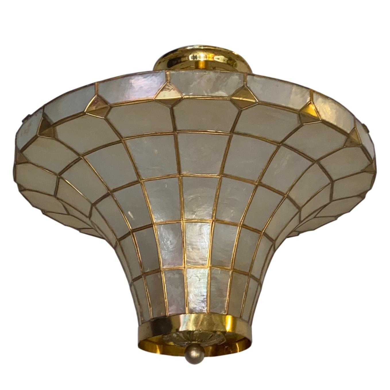 A late 1940's French capiz pendant light fixture with four interior lights.

Measurements:
Drop: 16