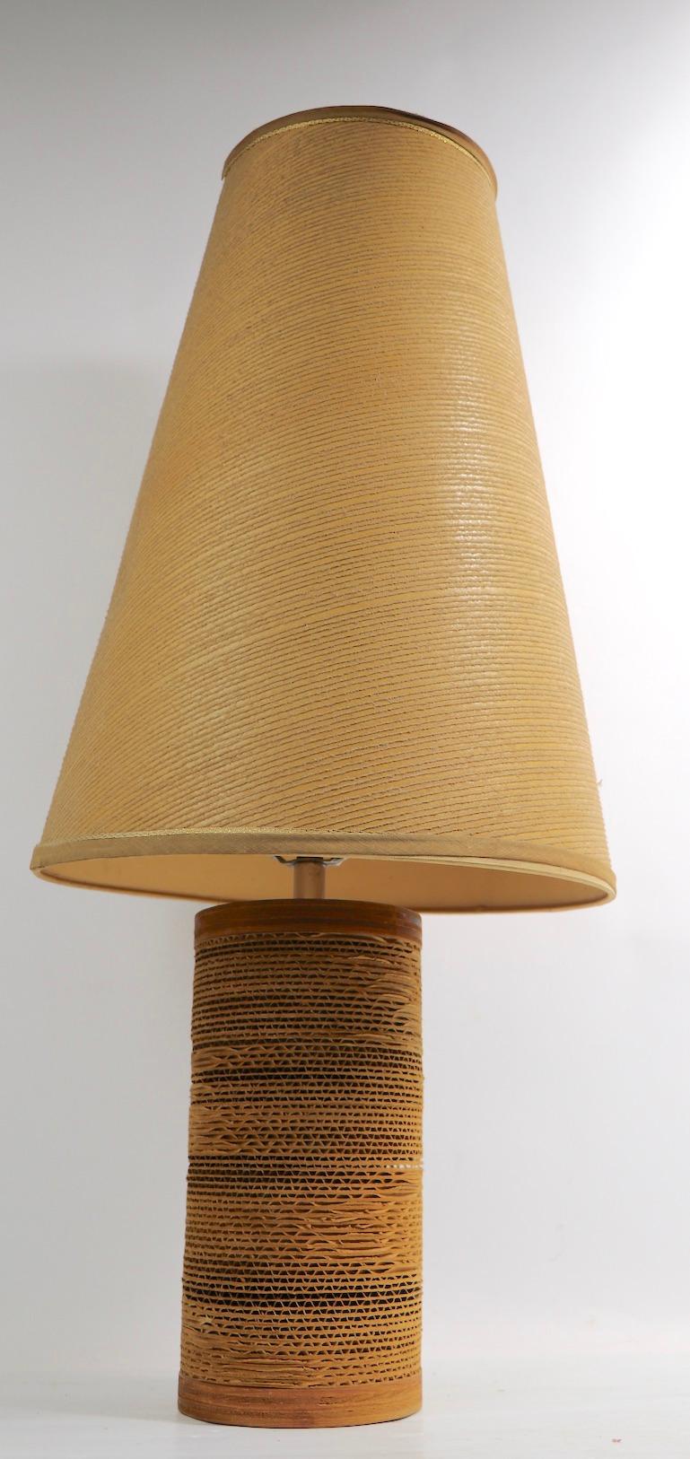 Nice cardboard, wood and chrome table lamp by Gregory Van Pelt, with original conical swirl pattern shade. This example is in very good, original clean, and working condition. Lamp base 5 in diameter x 10.5 height to top of body x 30 in H inc shade.
