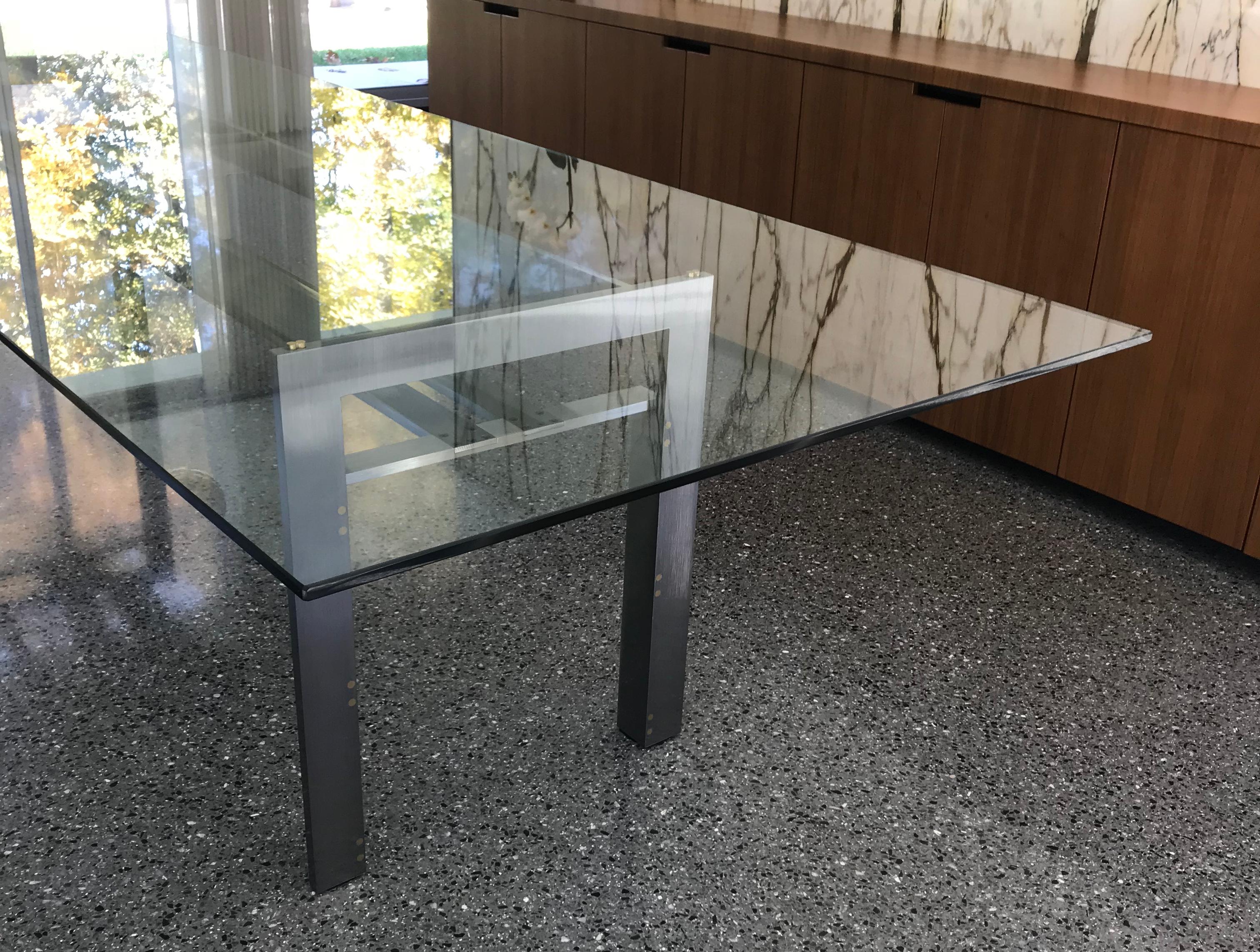 The Doge table, designed by Carlo Scarpa, one of the cornerstones of the “Ultrarazionale” movement. Solid brushed steel supports connected with allen screws and brass inset spacers, 1/2