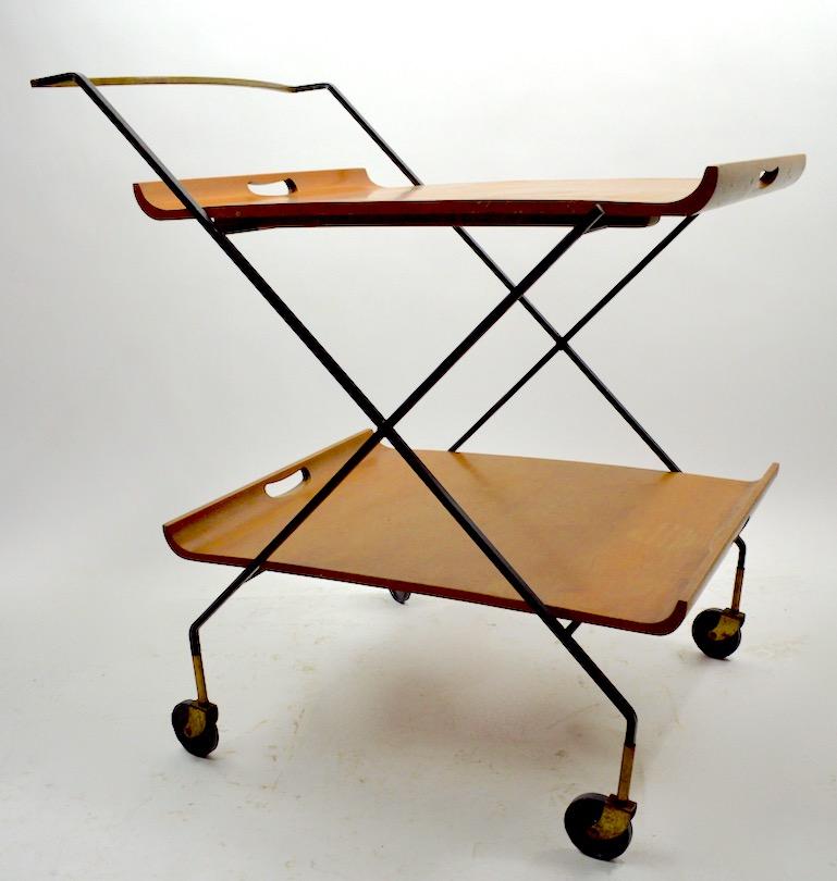 Classic midcentury serving bar cart designed by Milo Baughman for Murrey. This model features two removable serving trays (maple) on squared wrought iron frame with solid brass frame. Each tray 25.5 inch L x 19.75 W Lower tray 11 H Upper tray 27 H.