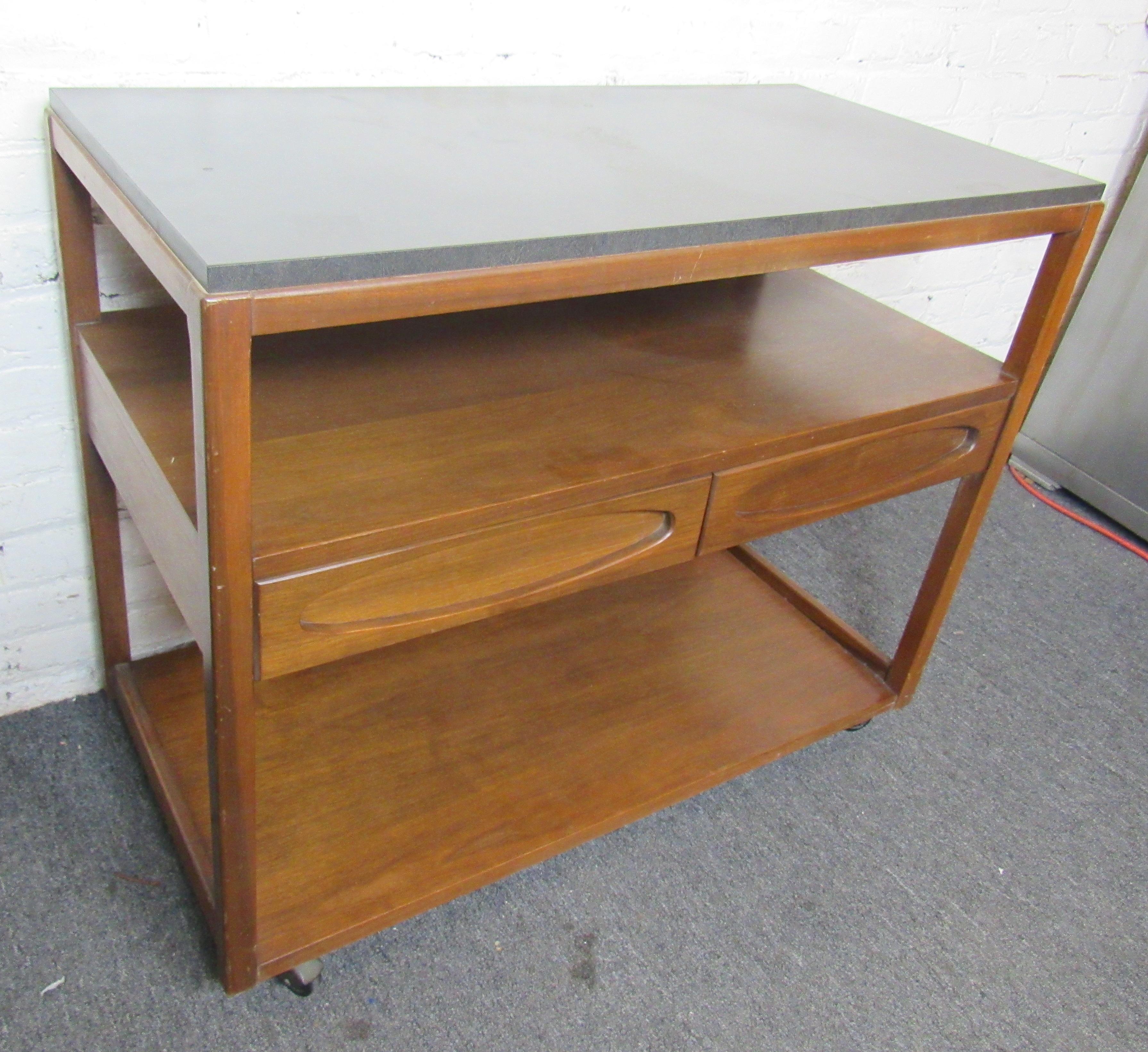 Rolling bar cart with two drawers and bottom liquor shelf. Laminate top used for liquids.
Location: Brooklyn NY.