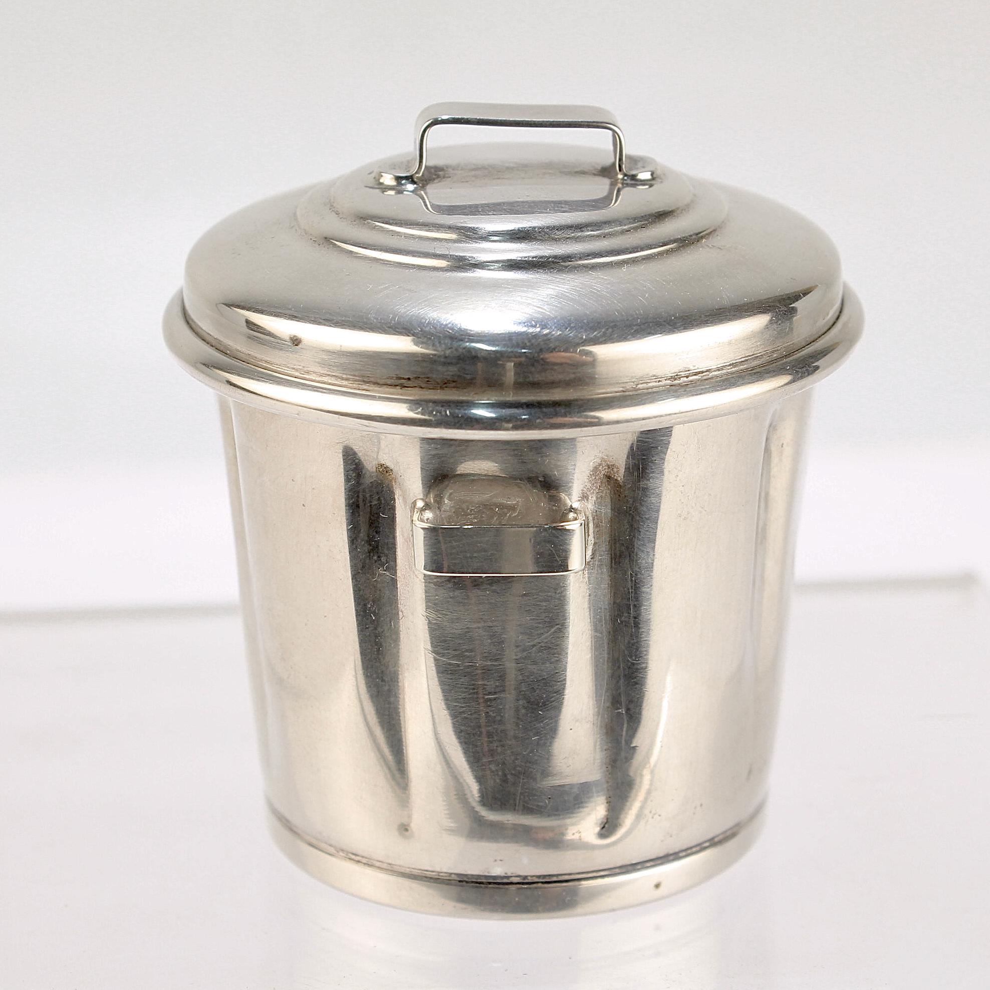 A fine sterling silver toothpick or cocktail spear holder in the form of a trash can.

Marked for Cartier.

Model no. 667. 

Simply a wonderful, whimsical accessory for the bar!

Date:
Mid-20th Century

Overall Condition:
It is in overall fair,