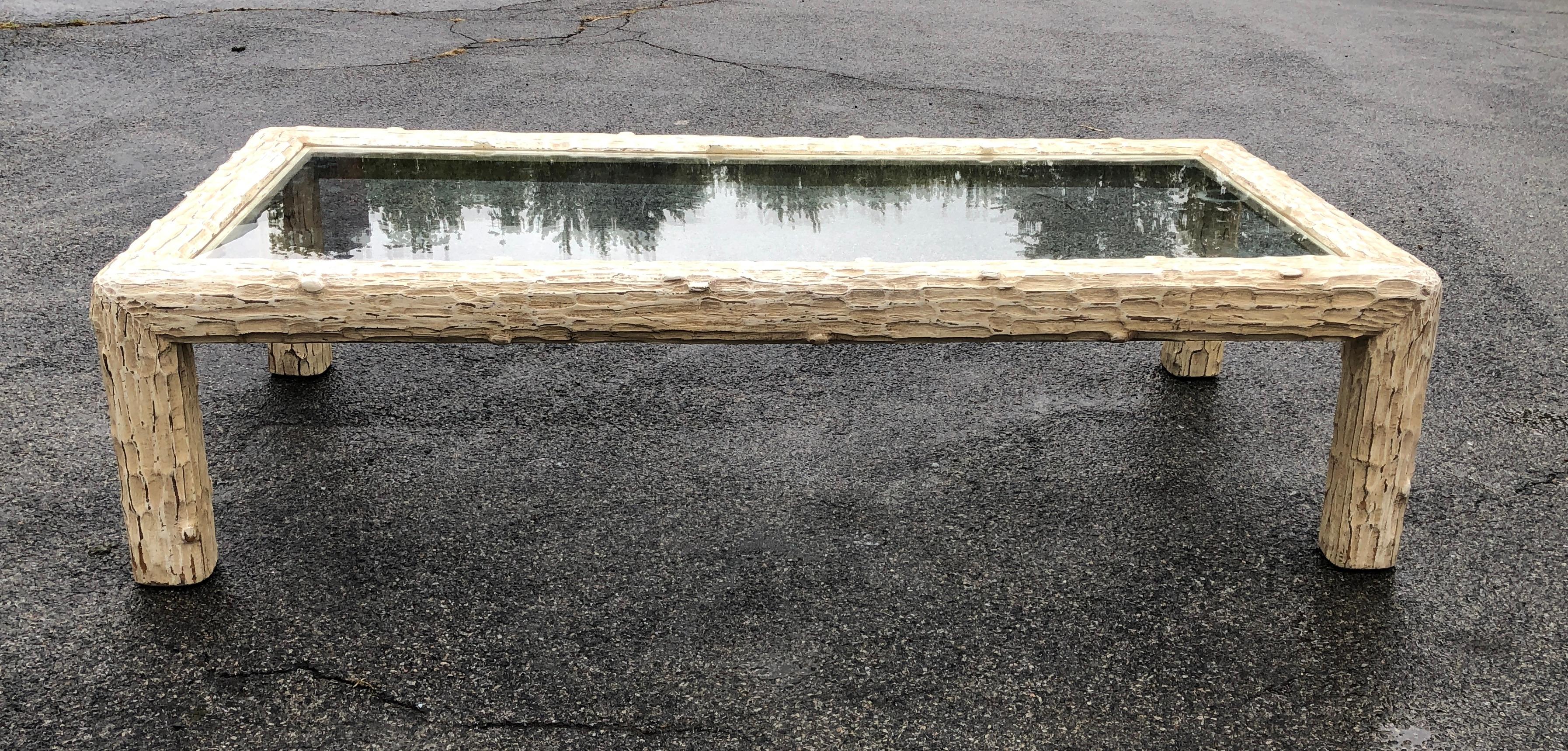 A very smart looking MidCentury Modern coffee table, with its wood base carved to look like tree bark. The original painted surface was distressed by the maker during the manufacturing process.  The size is great for a long sofa or an arrangement of