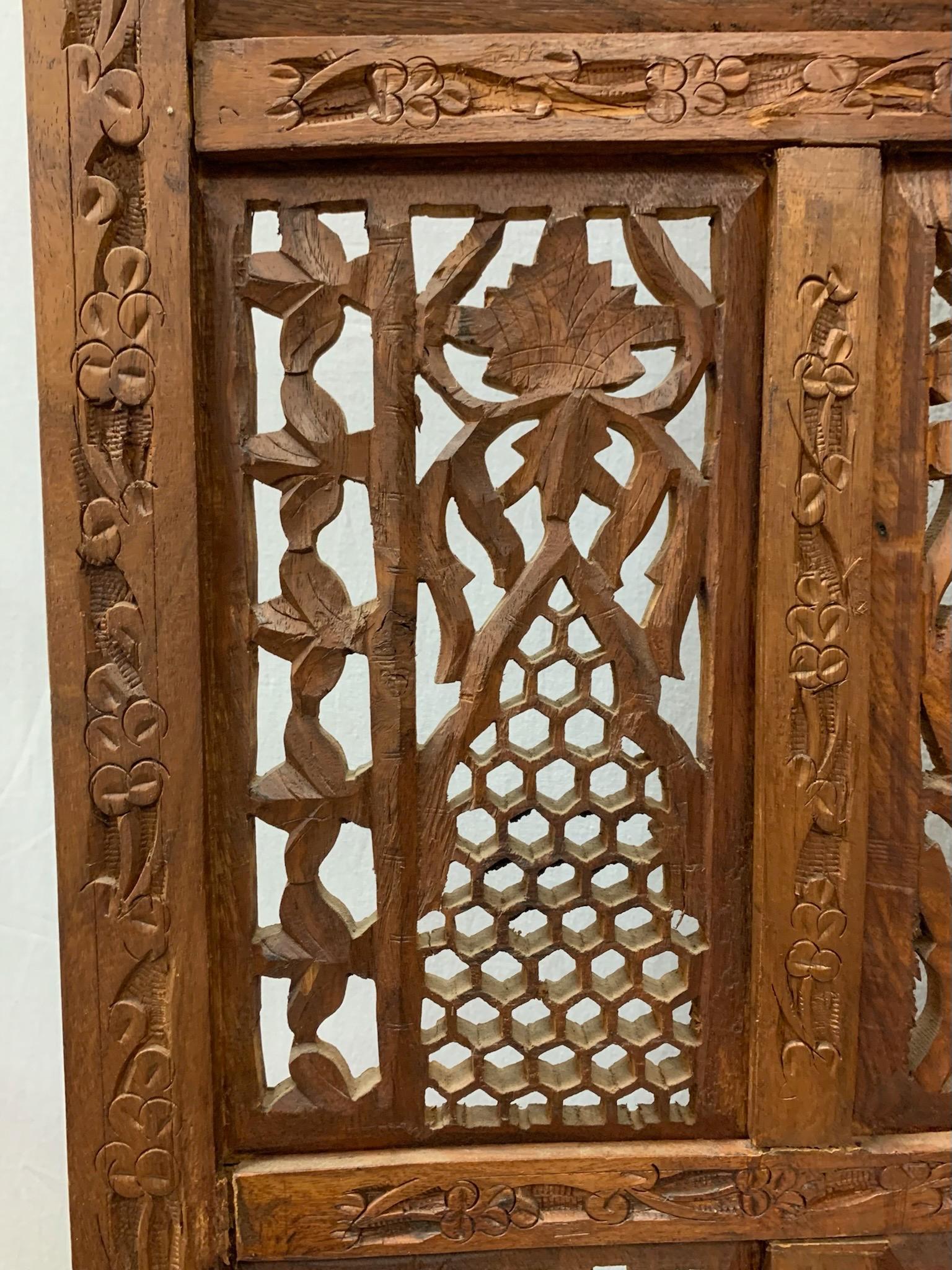 Stunning mid-century carved teak four panel screen features intricately hand carved leaf detail and the Taj Mahal.