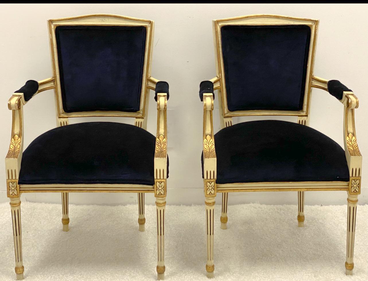 This is a pair of carved Italian arm chairs with neo-classical styling. The navy velvet upholstery is new. The chairs date to the 50s/60s, and they are not marked.