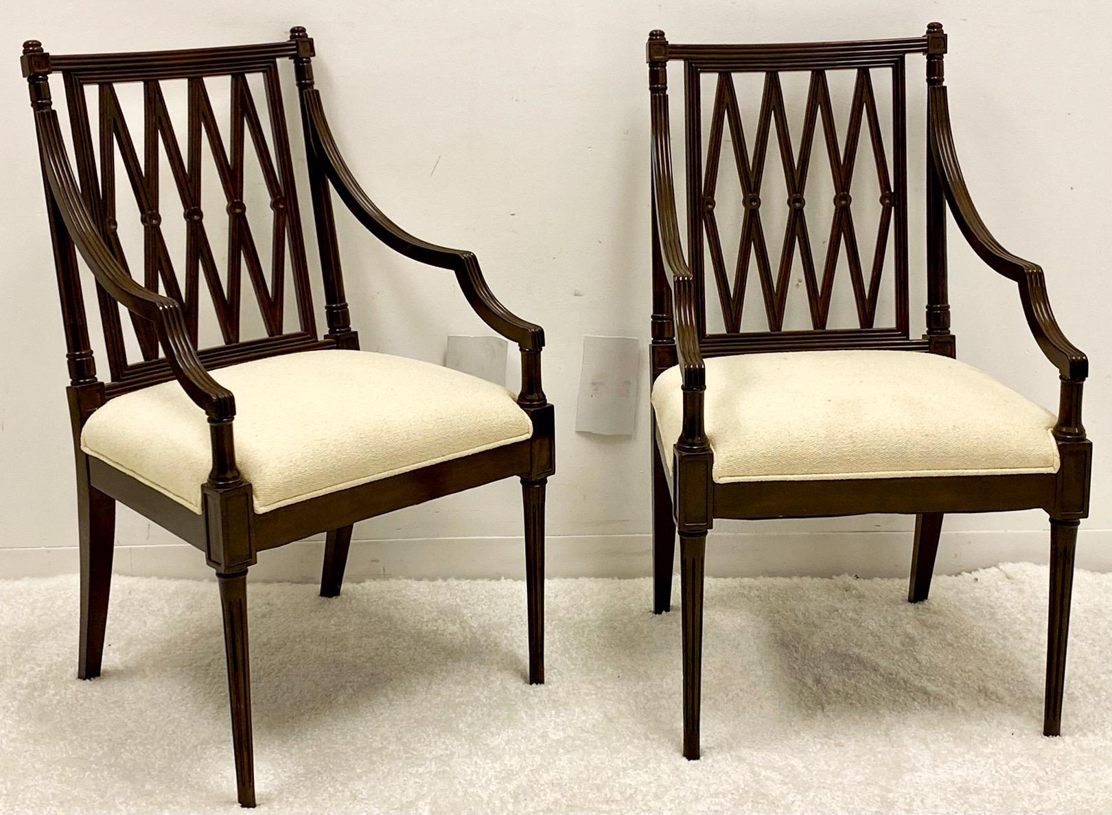 These wonderful regency style carved mahogany arm chairs have been recently upholstered in a neutral textured linen. They have tapered and fluted legs with lovely carved backs. They are unmarked. Measures: Arm;27”. Seat; 19”.
