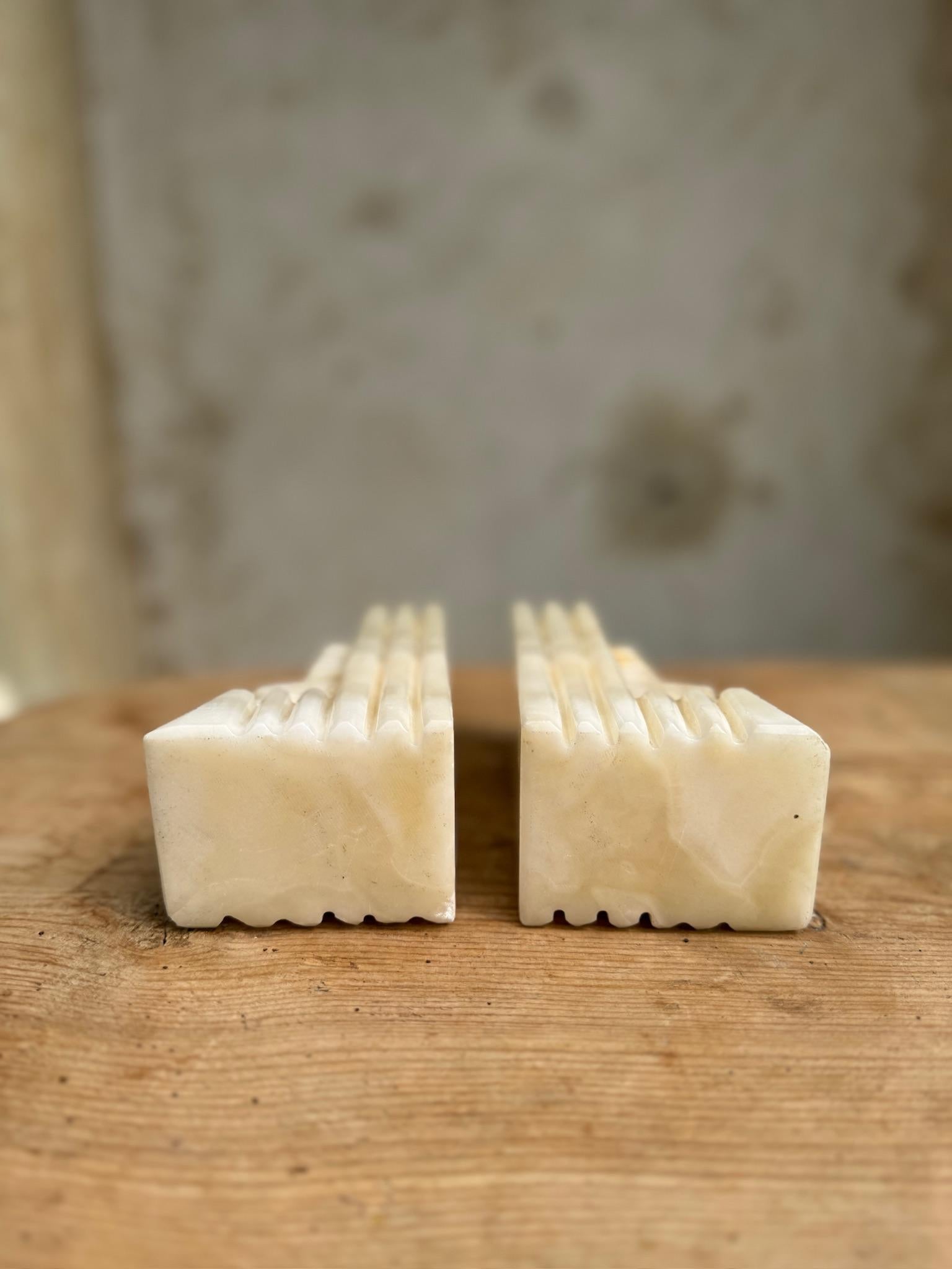 These pieces are meticulously carved from onyx stone, featuring detailed depictions of tribal Aztec or Mayan faces. The rich, natural hues of the marble bring warmth and depth, making these bookends a captivating statement piece. Perfect for