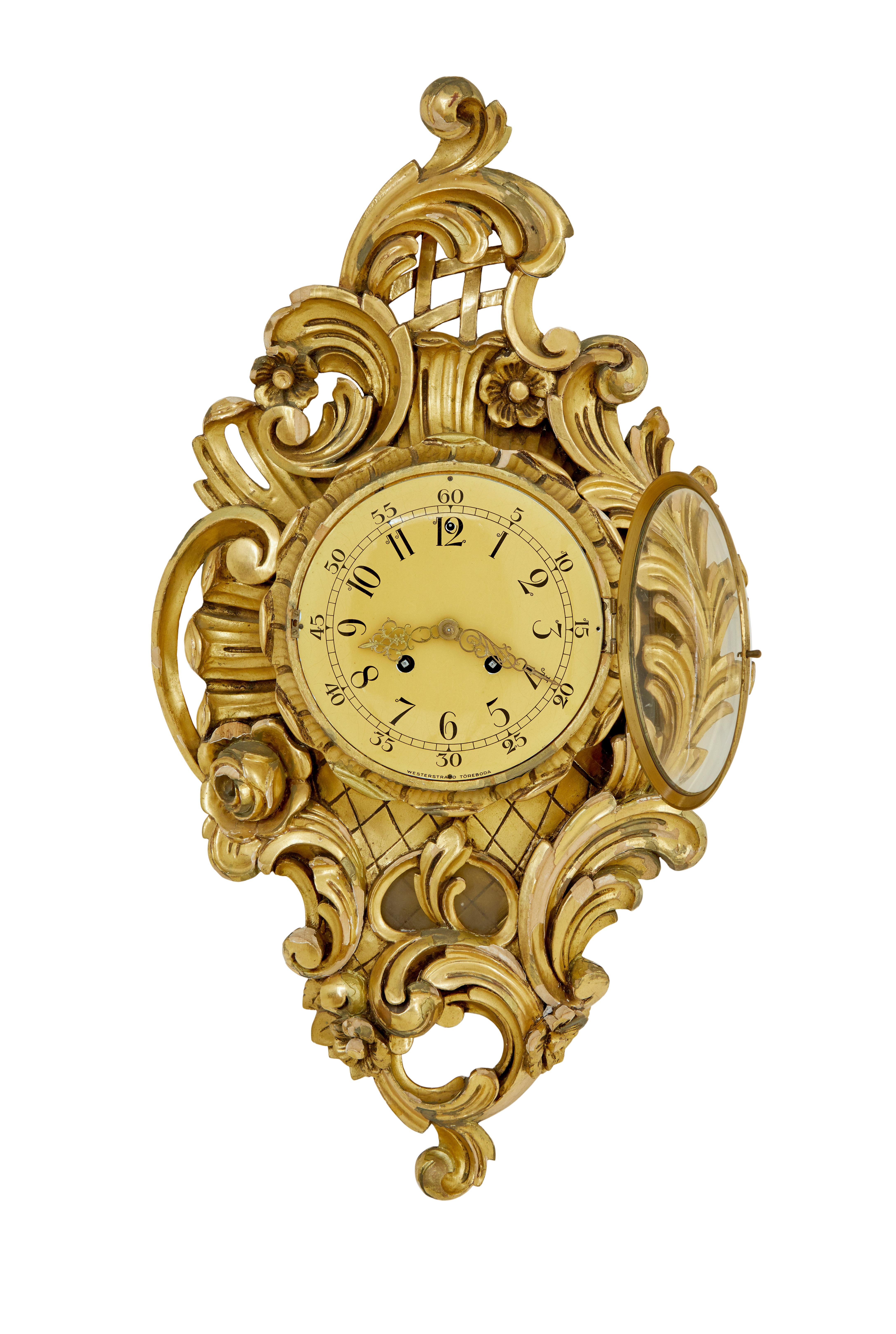 Mid century rococo revival gilt clock by Westerstrand circa 1950.

Good quality rococo influenced clock by well known Swedish maker Westerstrand Toreboda.

Fitted with a twin train 8 day movement and original pendulum.  Enamel clock face with arabic