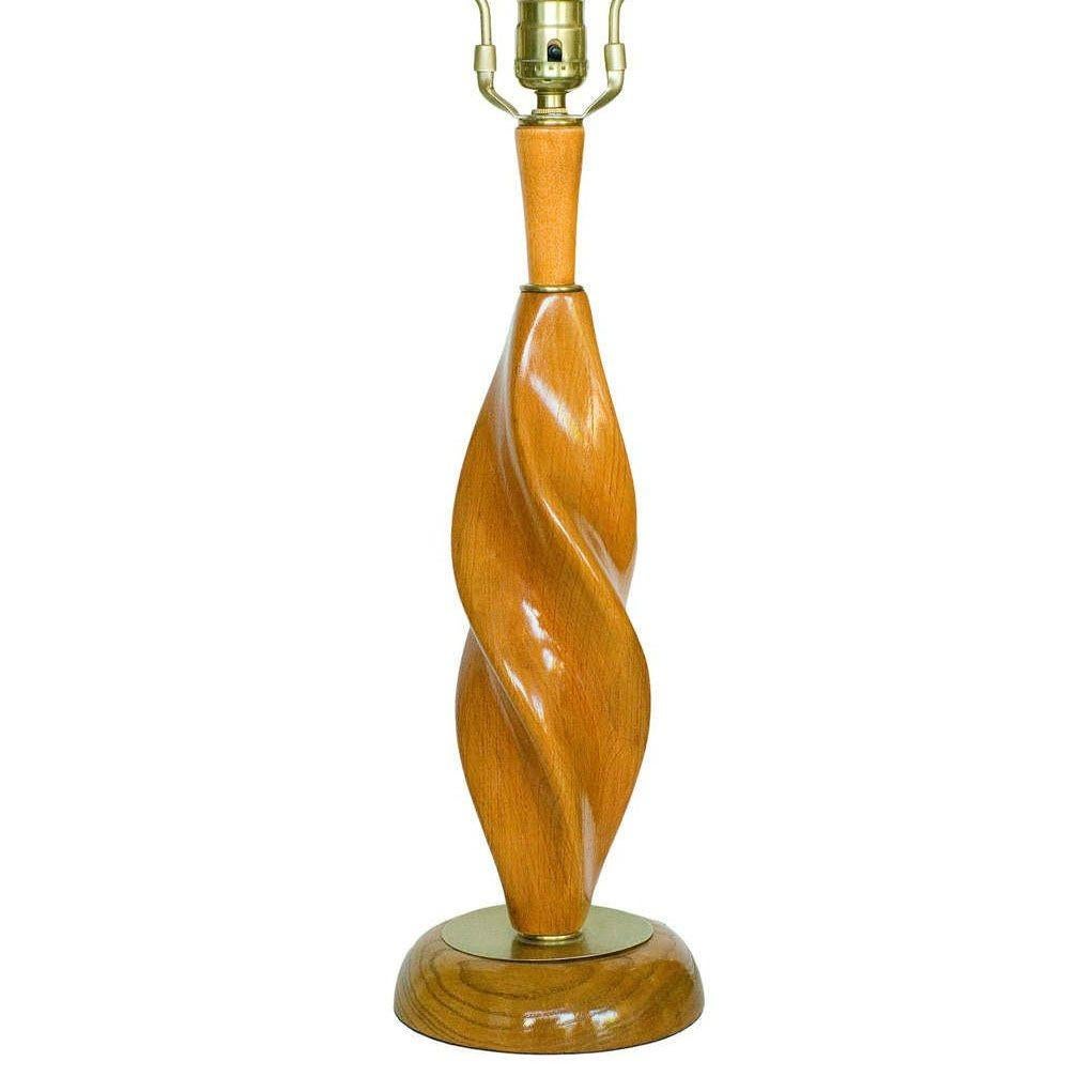 A striking pair of Mid-Century Spiral Carved Oak and Brass Sculptural Table Lamps by Yasha Heifetz. Each lamp embodies the bold modern artistry and craftsmanship the artist is known for, carved in a flowing spiral pattern with a dynamic sense of