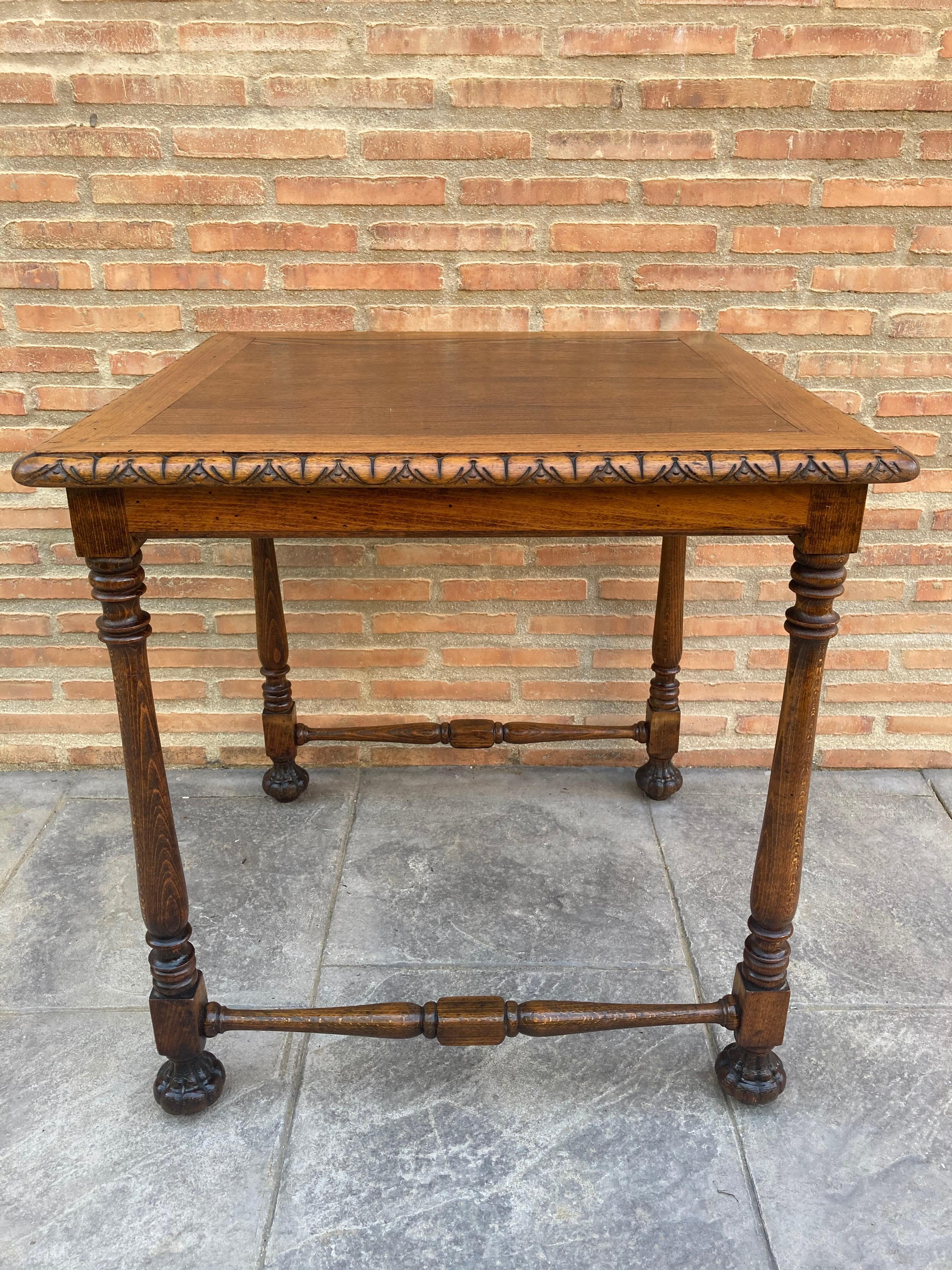Mid century carved square walnut side table Louis Philippe style. 
Extraordinary Castilian walnut wood side table, with elaborately carved legs, edge of the tabletop and chambranas.