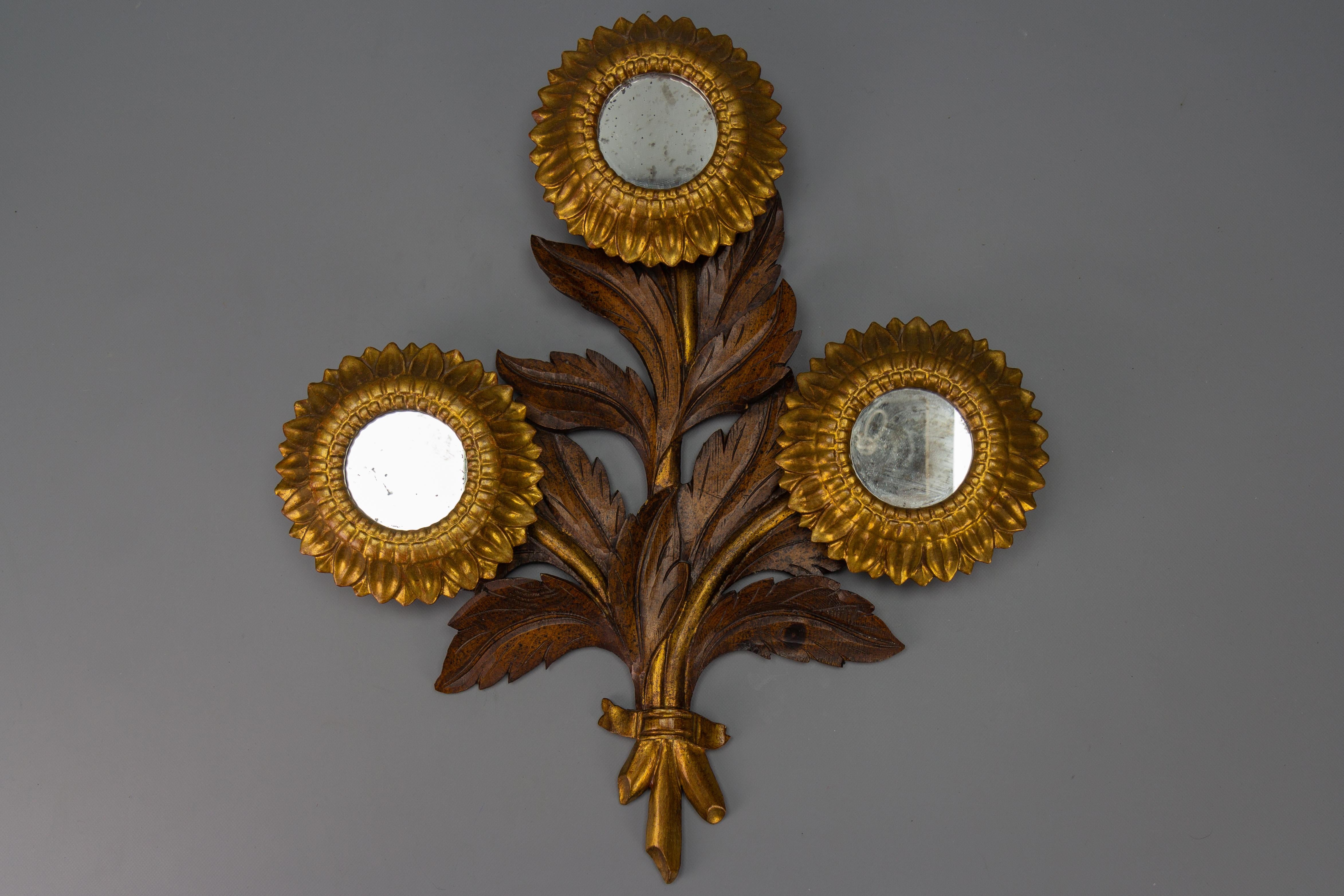 Mid-Century Carved Sunflower-Shaped Brown and Golden Wall Mirror, 1950s
This beautiful and unusual wall mirror or wall decor in the shape of a sunflower is carved and made of wood with three flowers, centered with round mirrors, and colored in