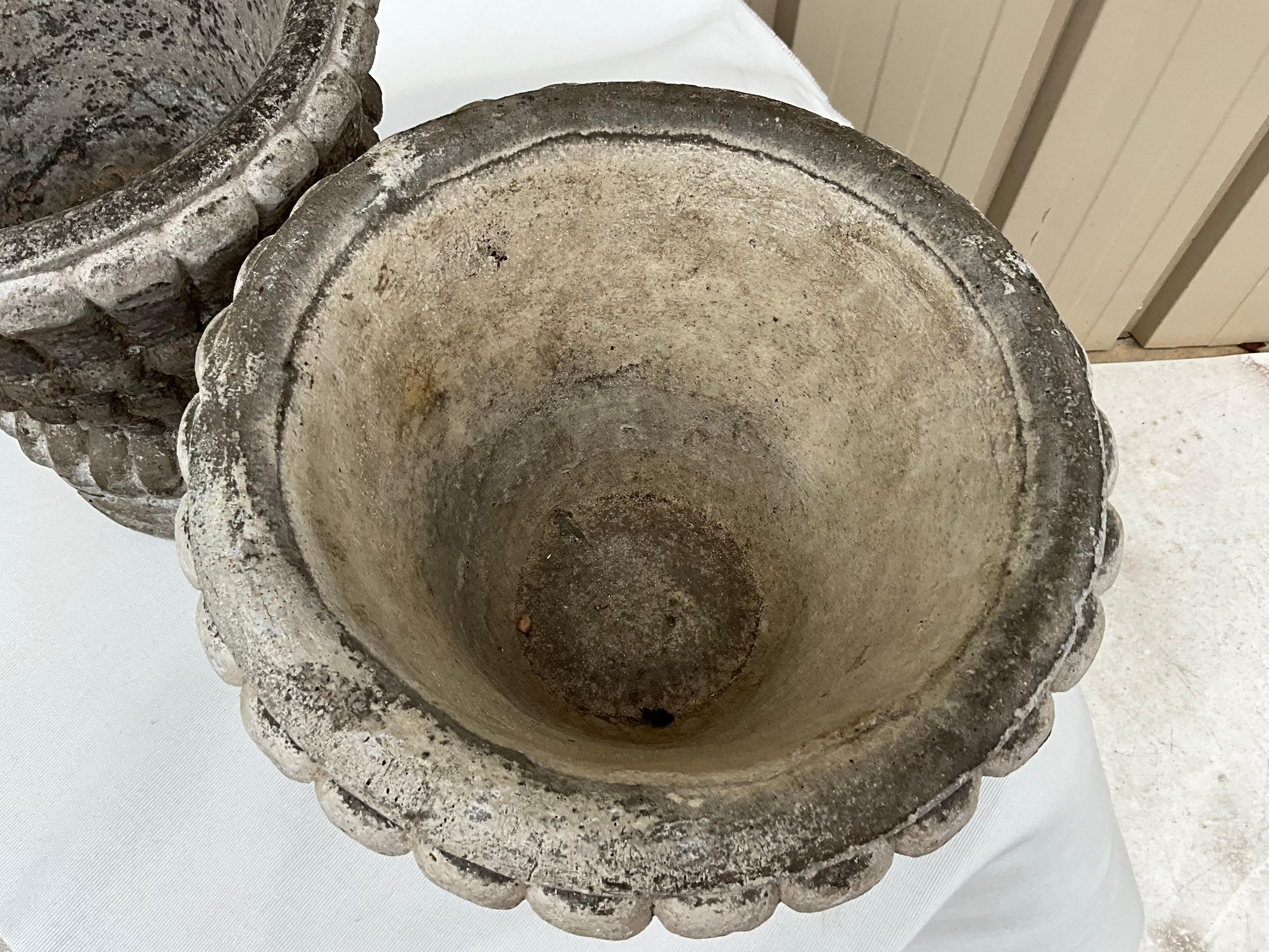 This is a pair of unique cast concrete planters. As one can see, one is significantly darker than the other. They most likely date to the 50s/60s. They are unmarked.