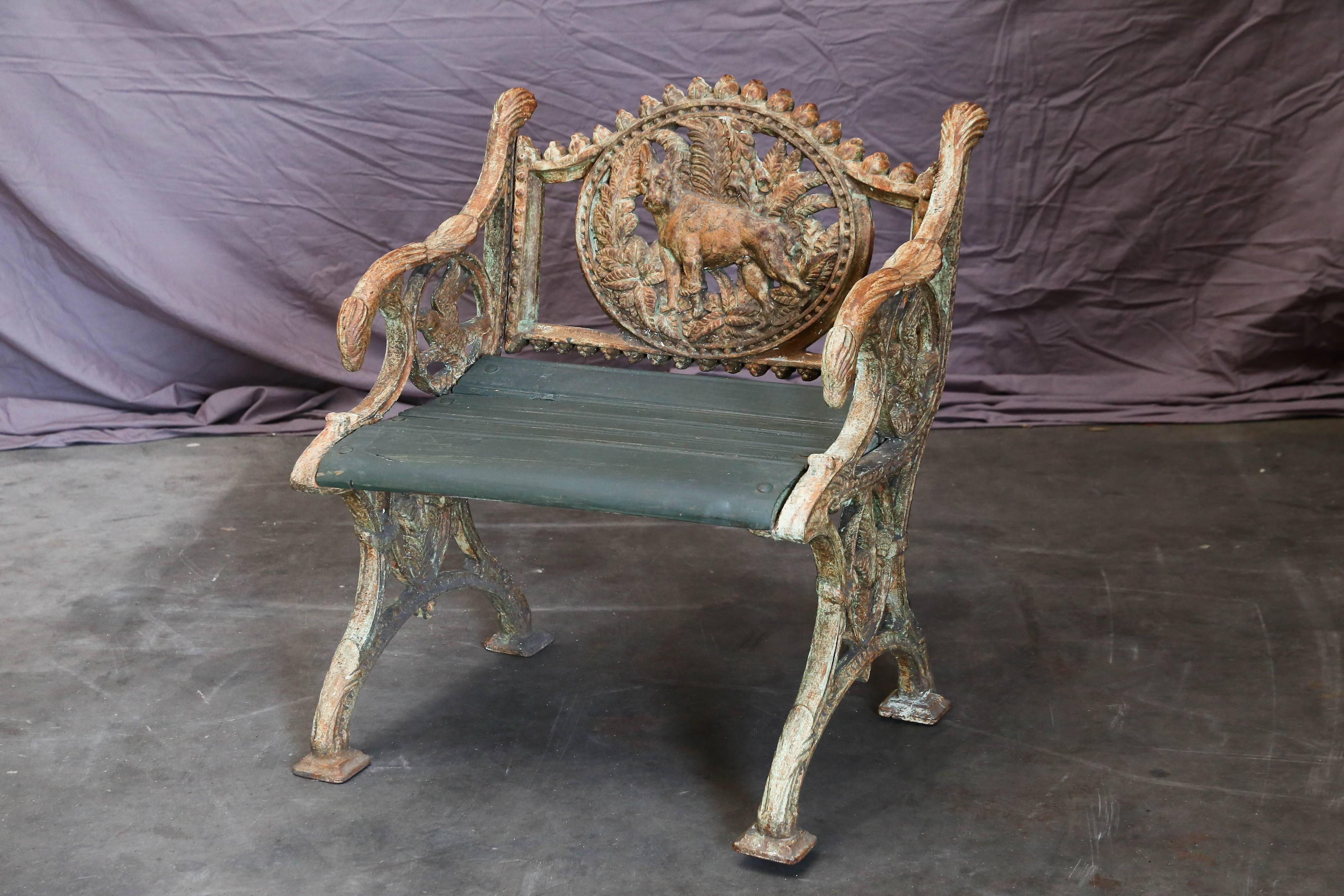 Chairs like these were cast in old foundries in Calcutta and were extensively used in colonial rail road stations. The wooden seats would be replaced when the seats were worn out. This one has a dog emblem. These benches can be used in outdoor