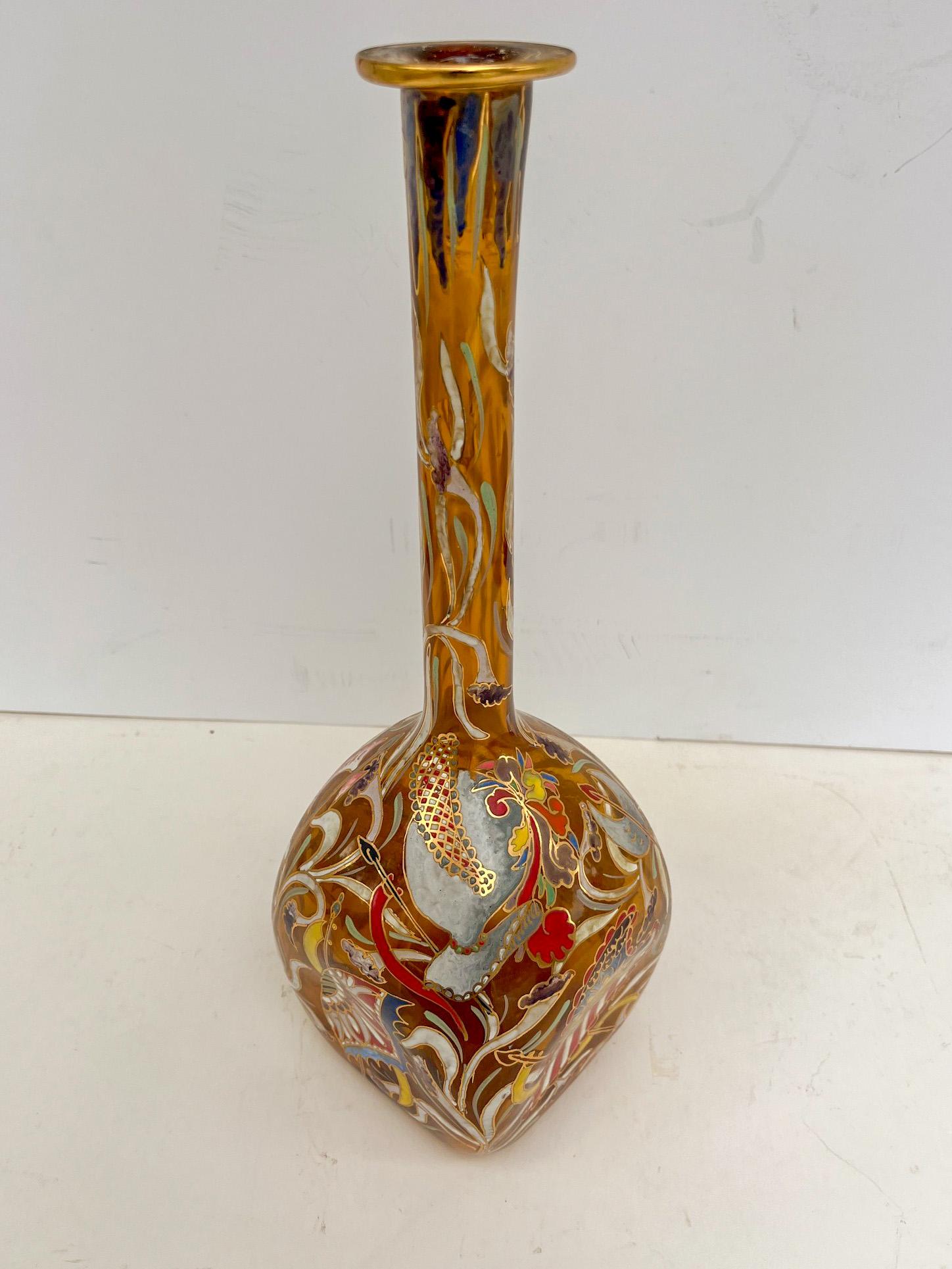 Mid-Century Catalan Art Glass Long Neck Bottle Vase.

A vintage Moser style blown, molded and hand painted in polychrome enamels bottle.  The bulbous, long necked amber crystal is hand painted all over in raised enamels and finished with gilt