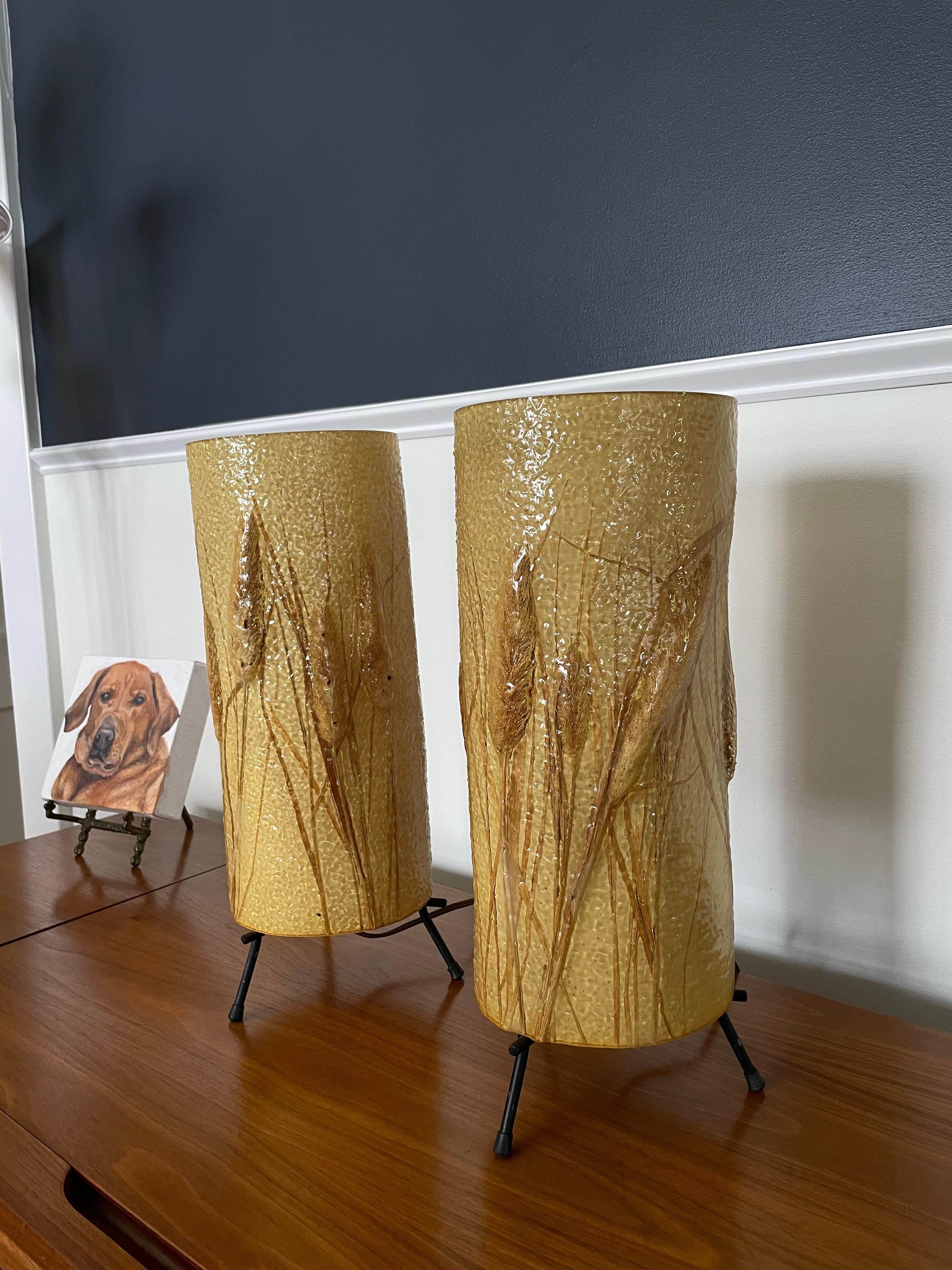 Awesome Mid Century Cattail lamps made out of a textured rubber material wrapping canvas interior . Cylindrical for 360 degree effect. Great graphics and glow.
