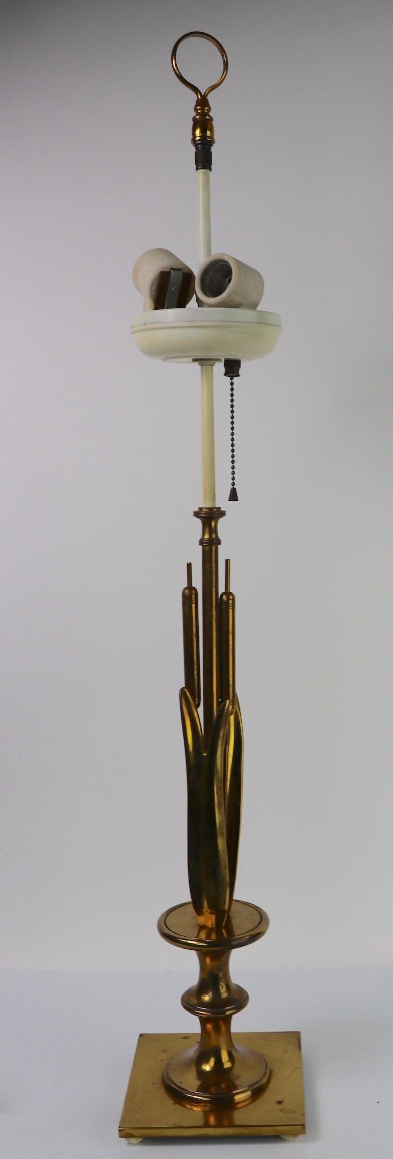 Brass table lamp with cattails. The lamp accepts three standard screw in bulbs, each operates independently to control brightness. Original clean and working condition, lamp does not include shade.