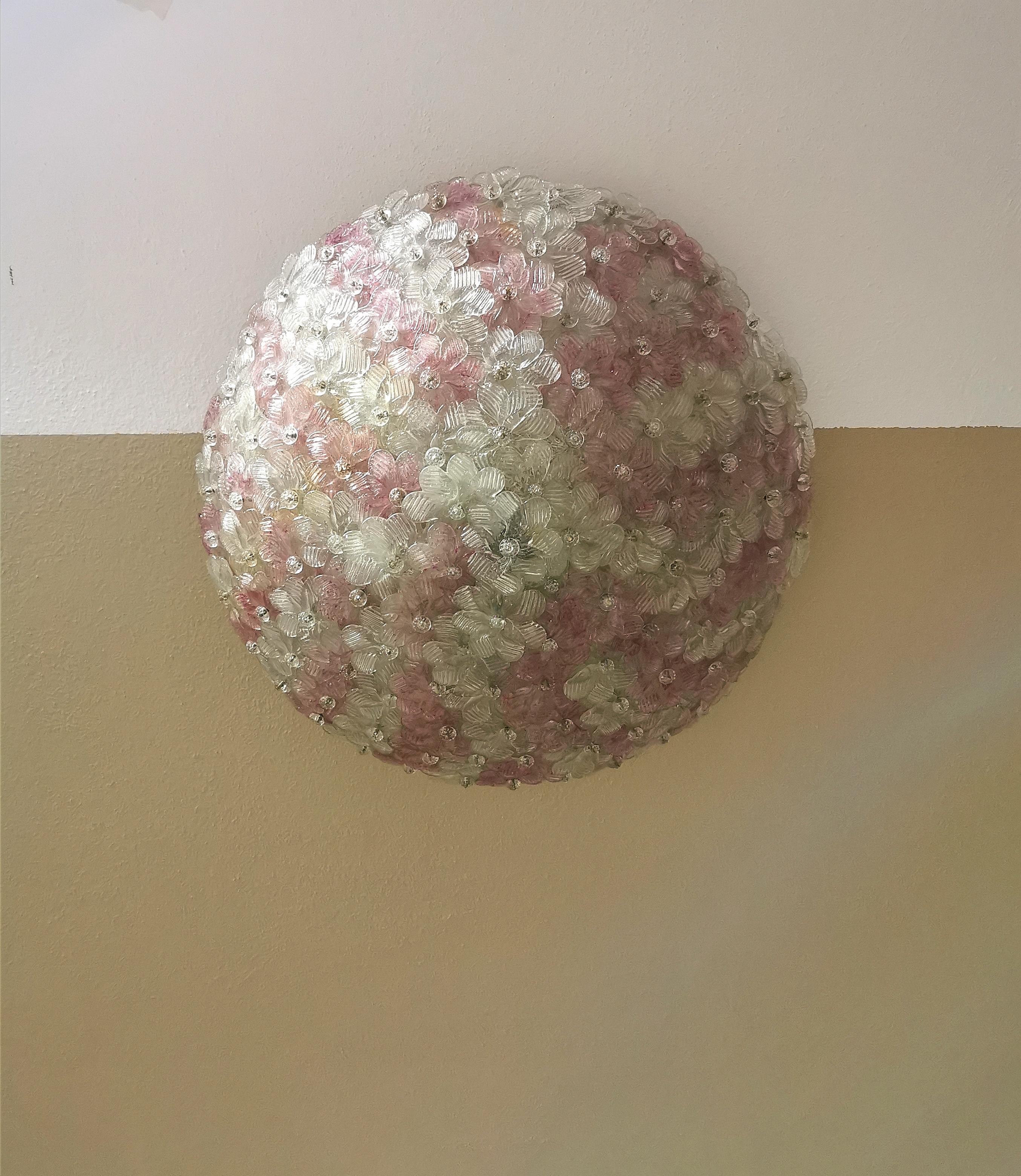 Big half sphere ceiling lamp by Barovier & Toso. The lamp has two lights with a white enameled metal structure covered with transparent Murano glass flowers with pink details. Italy in the 1960s.
  