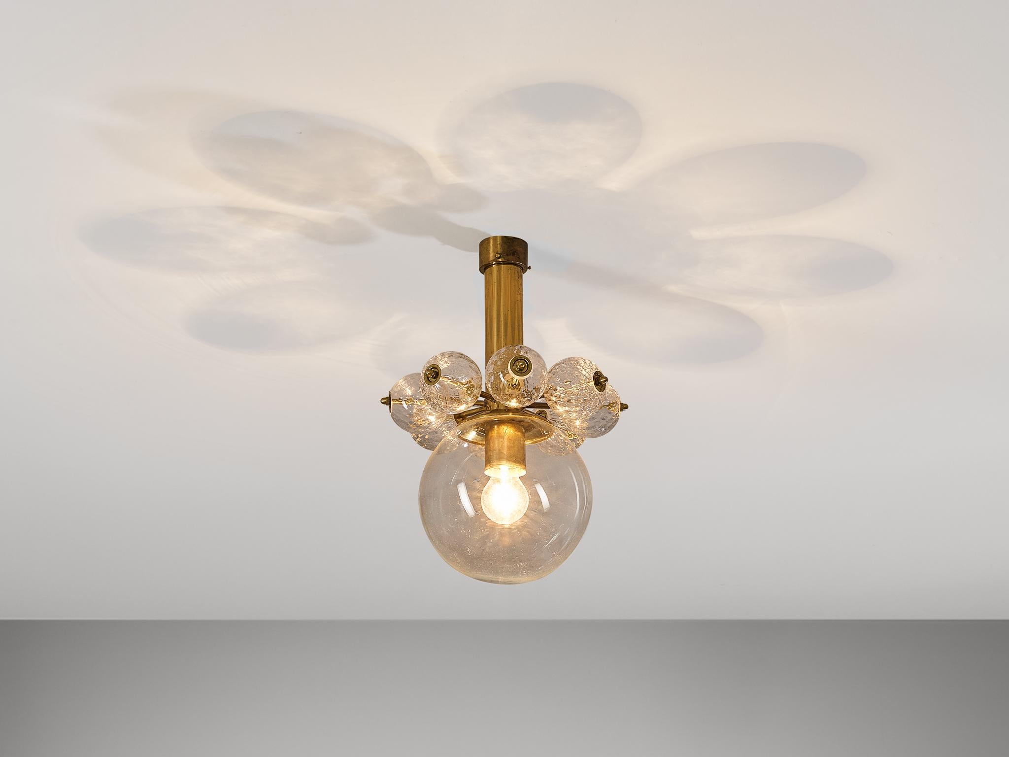 Chandelier, brass, blown glass, Czech Republic, 1960s.

This ceiling light features a delightful composition combined with the use of fine materials. The cylindrical-shaped canopy simultaneously functions as a socket holding the light source which