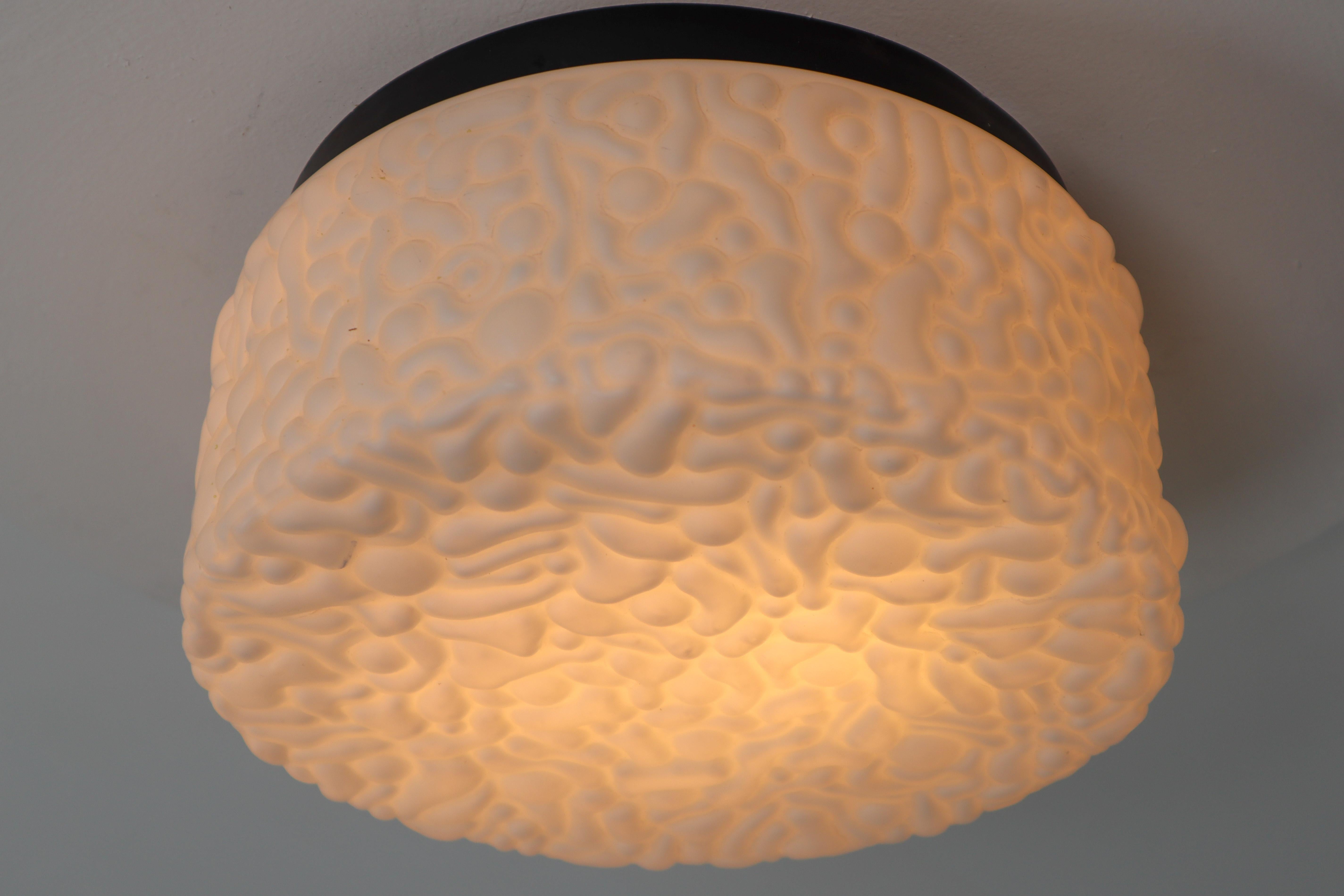 Midcentury ceiling light or wall scones with steel frame lacquered fitted with two E27 bulbs with opaline glass shade, Europe, 1960s. The glass has pattern in it, what gives a nice diffuse light effect and a nice pattern on ceiling and walls, these