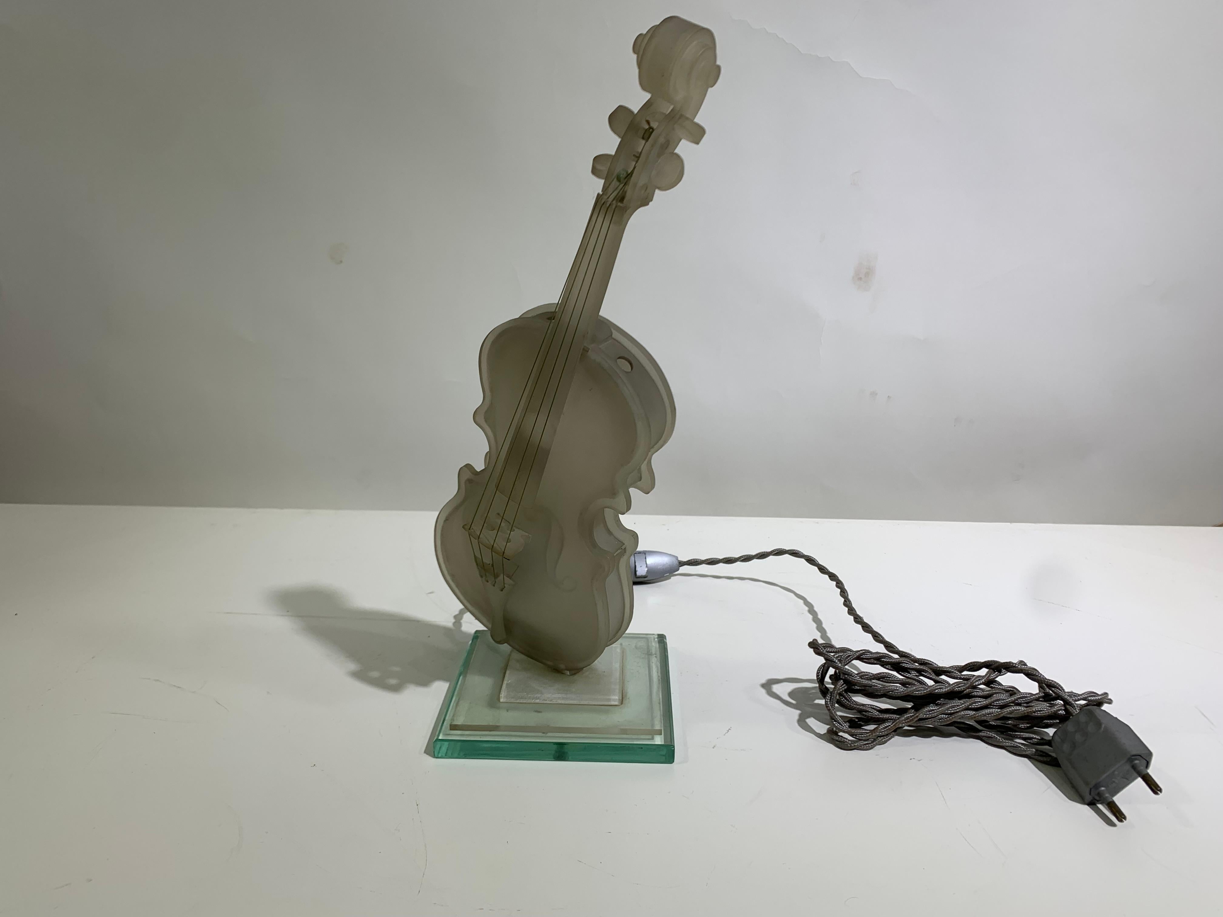 A charming Cello in plexiglass table lamp, providing a beautiful ambiance once lit, fixed on a square glass base with a 250 cm chord.

W11.5 D11.5 H33.5 cm , Weight : 0.1 kgs.